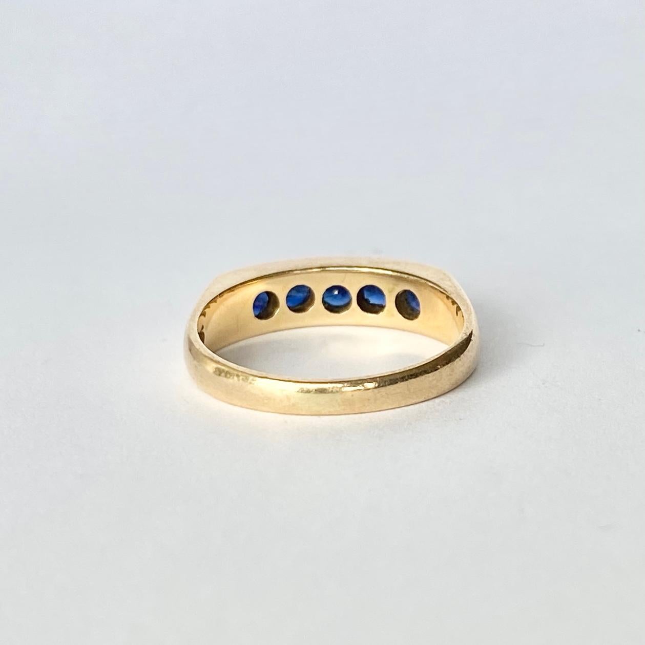 The sapphires in this ring are a deep blue colour and are set in an ornate square detailed gallery all modelled in 14ct gold. The stones total 50pts. 

Ring Size: L 1/2 or 6 
Band Width: 5mm
Height Off Finger: 3mm

Weight: 3.3g