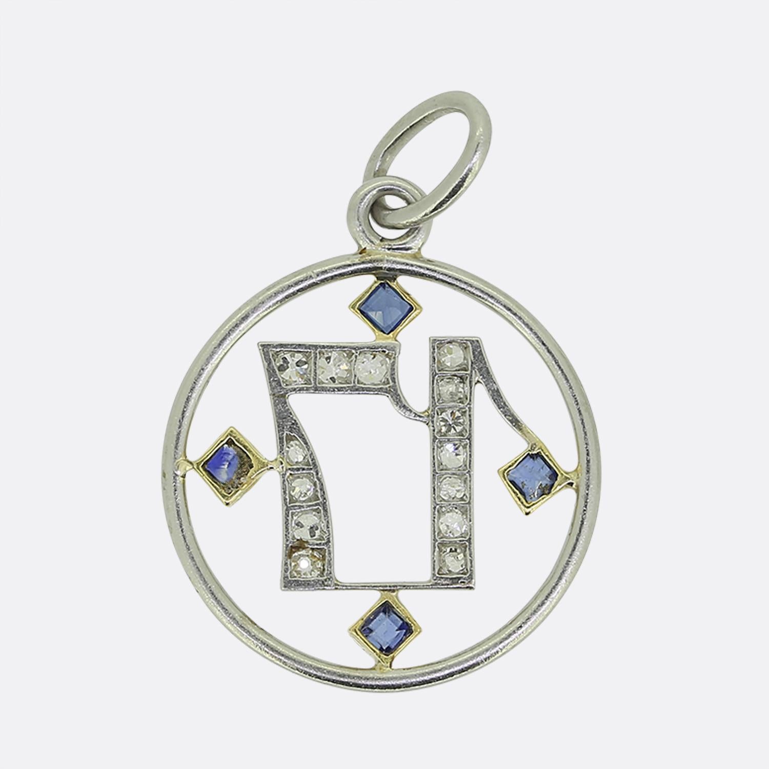 Here we have a delightful pendant come charm crafted during the Art Deco movement. This platinum piece showcases a '17' motif at the centre of an open circular frame adorned with round faceted old mine cut diamonds. Surrounding the number is a