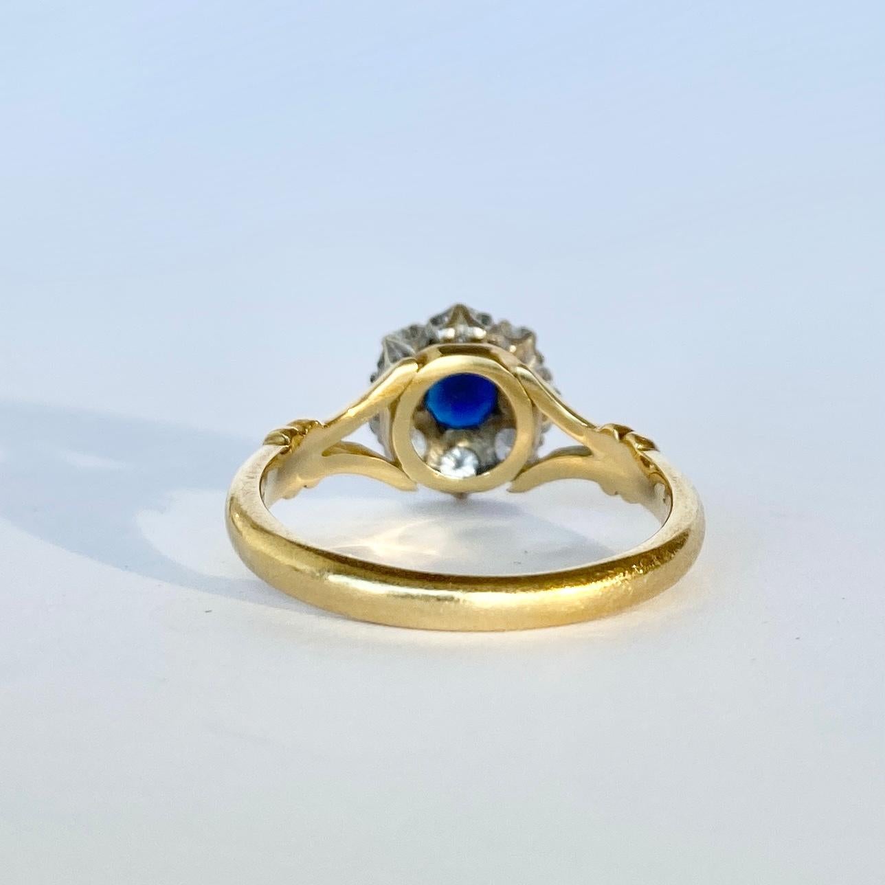 This classic cluster ring holds a central sapphire and diamonds around the edges all set in platinum. The sapphire is a deep blue colour and measures 40pts and the diamonds total approximately 40pts. 

Ring Size: O or 7 1/4 
Cluster Diameter: 10mm