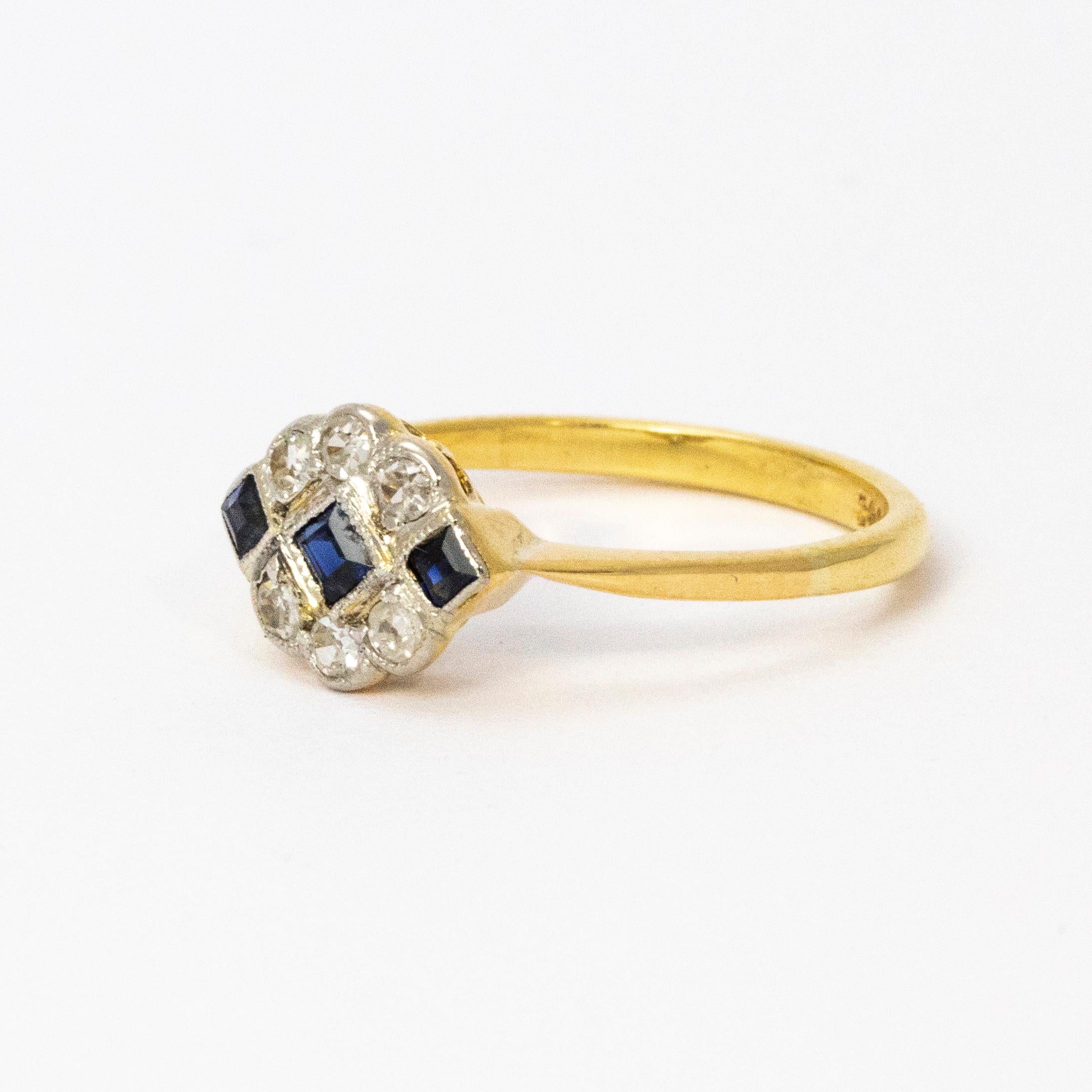 A stunning 1920s Art Deco ring. Centrally set with three brilliant blue square cut sapphires arranged horizontally across the face. Above and below sit curves of six wonderful white diamonds. Modelled in 18 karat yellow gold.

Ring Size: UK K 3/4 or