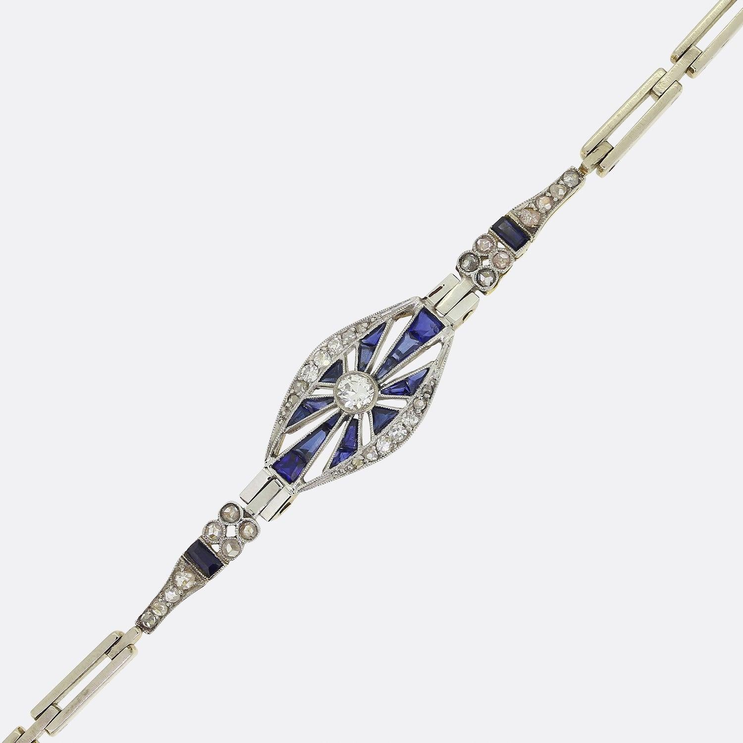 This is a truly wonderful sapphire and diamond bracelet from the Art Deco era. The bracelet features a central transitional cut diamond surrounded by rich blue calibrated sapphires and old cut diamonds both above and below. The back of the bracelet