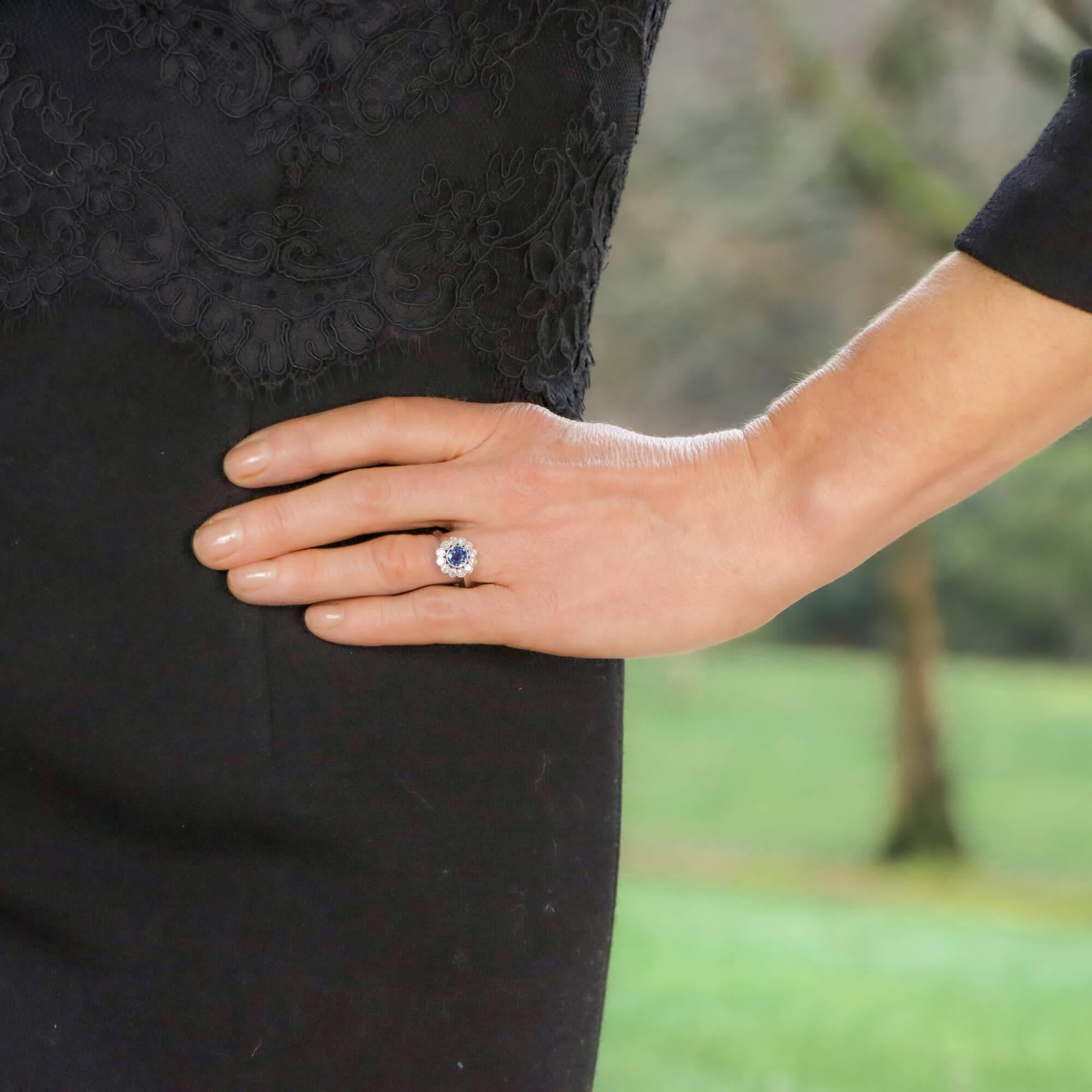A beautiful Art Deco sapphire and diamond coronet cluster engagement / dress ring set in platinum.

The ring predominantly features a natural and unheated light blue sapphire which is encased in a platinum millegrain setting. The sapphire is then