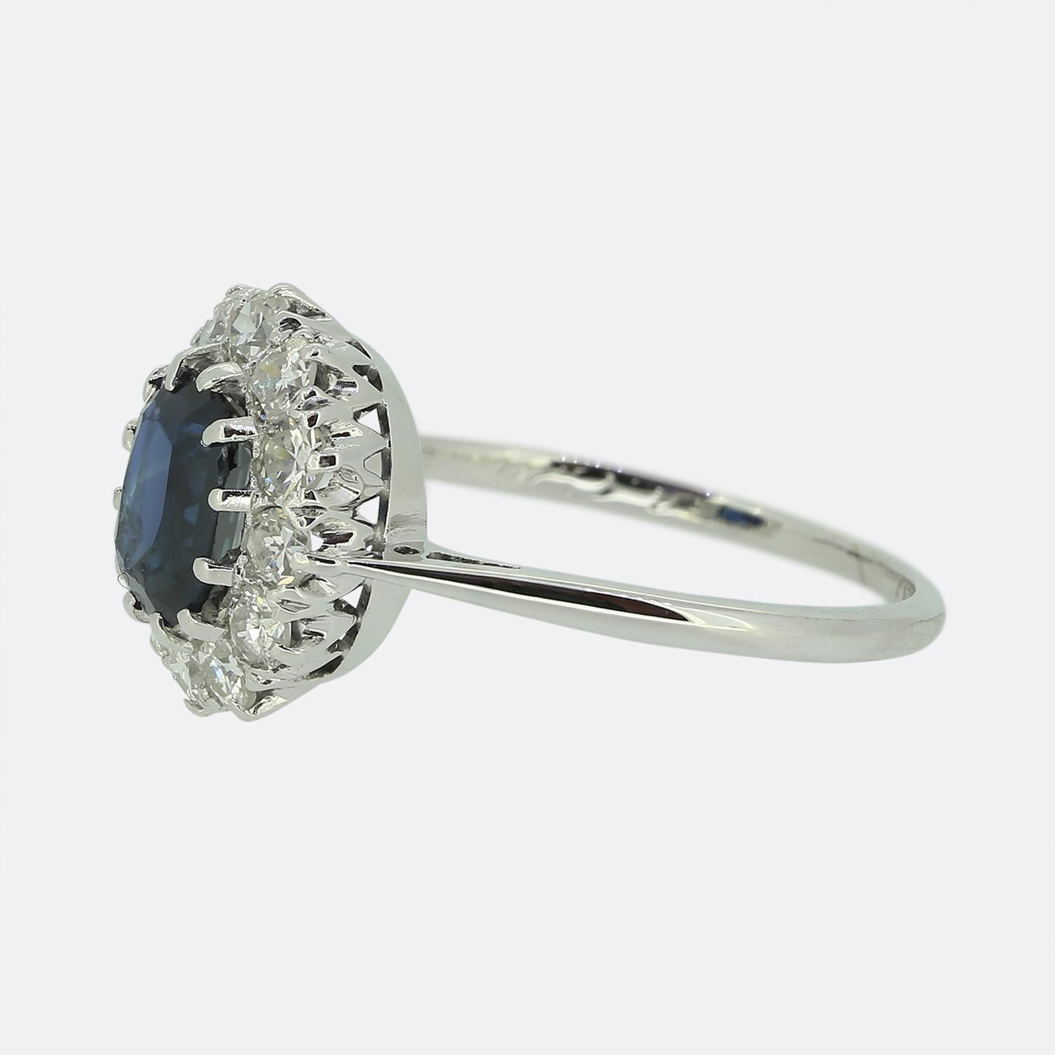 This is a truly wonderful sapphire and diamond cluster ring dating back to the Art Deco era. The central sapphire is raised in a claw mount and surrounding it there are 12 old European cut diamonds. The central sapphire is a mid to dark blue tone