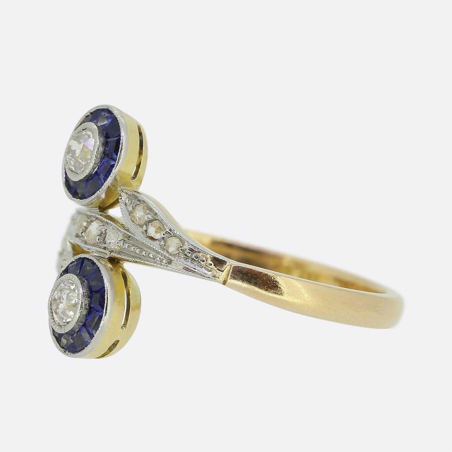 Here we have a wonderfully original ring from a time when the Art Deco style was at the height of design. Focally, we find a duo of matching sapphire and diamond target clusters split through the centre by a rose cut diamond set floral motif. All