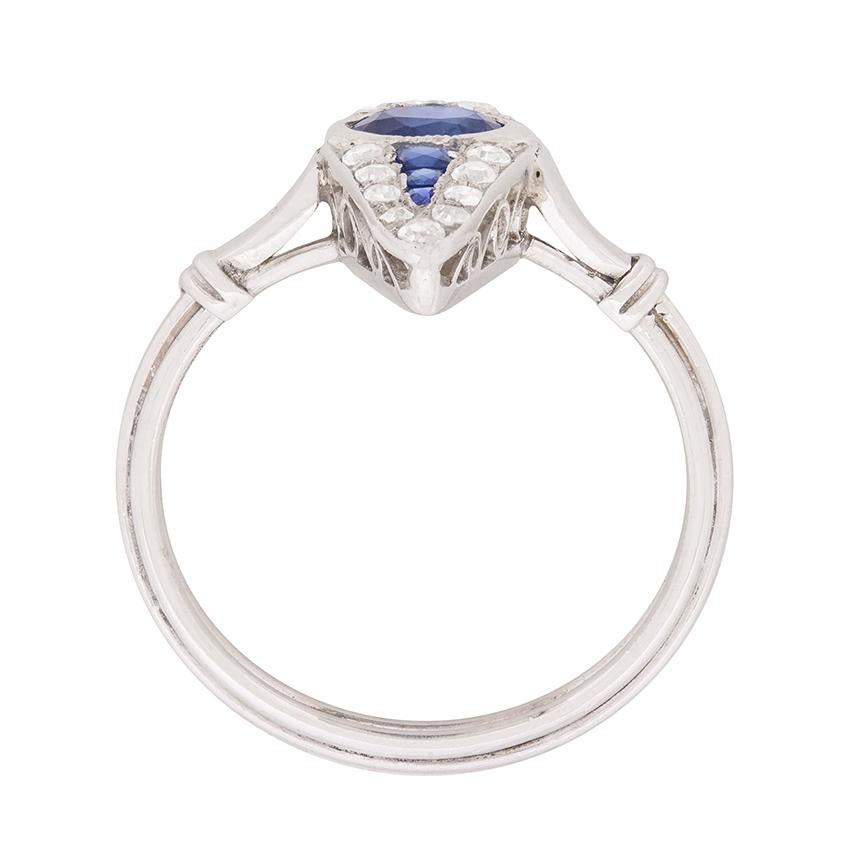 This unique ring is full of character and would be the ideal every-day wear dress ring. It is marquise shaped and has a central sapphire which is a rich blue colour. The oval sapphire weighs 0.50 carat and the remaining sapphires, which are french