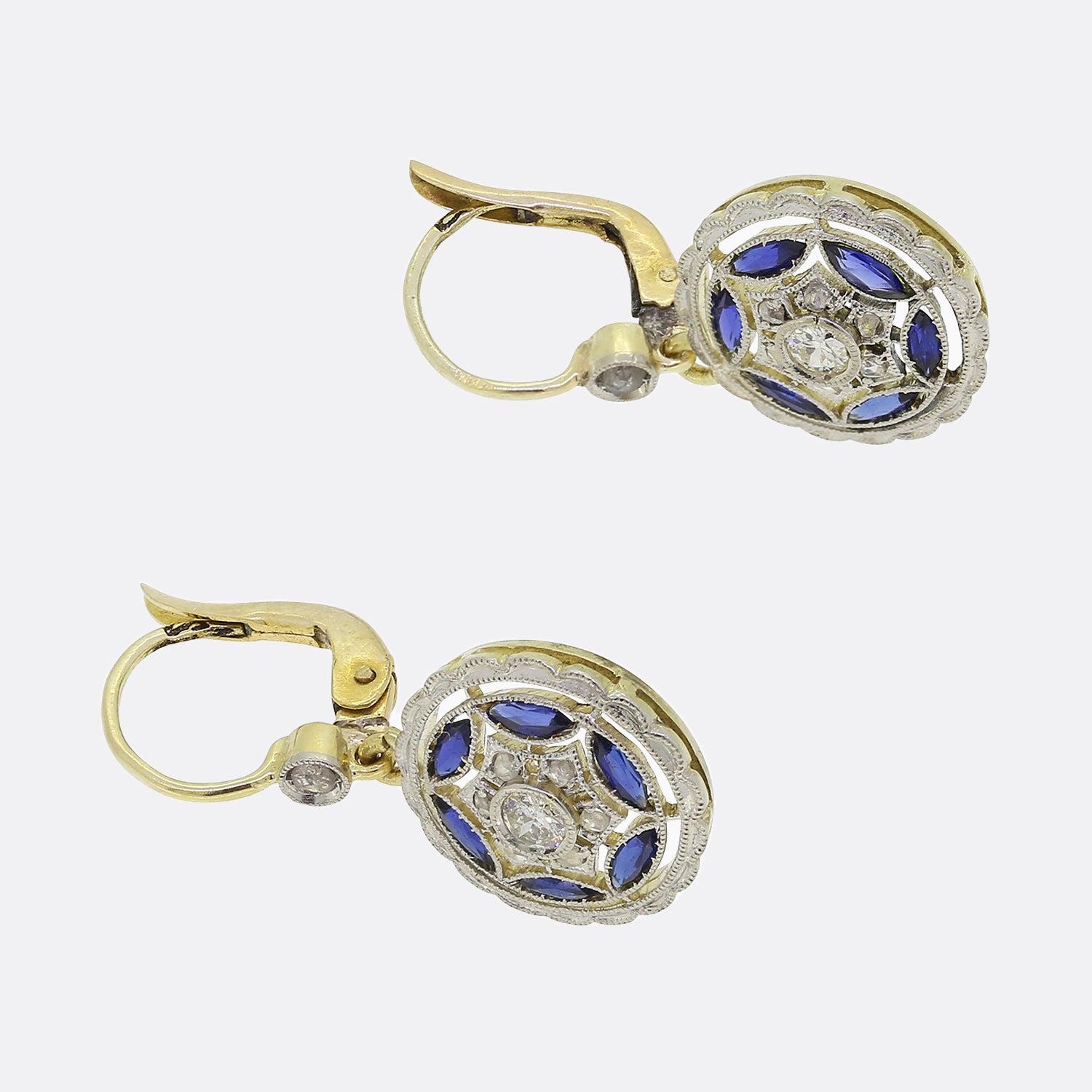Here we have a meticulously crafted pair of drop earrings from a time when the Art Deco style was at the height of design. A round structure plays host to outstandingly detailed milgrain bordering. Firstly, a double web like frame holds a round