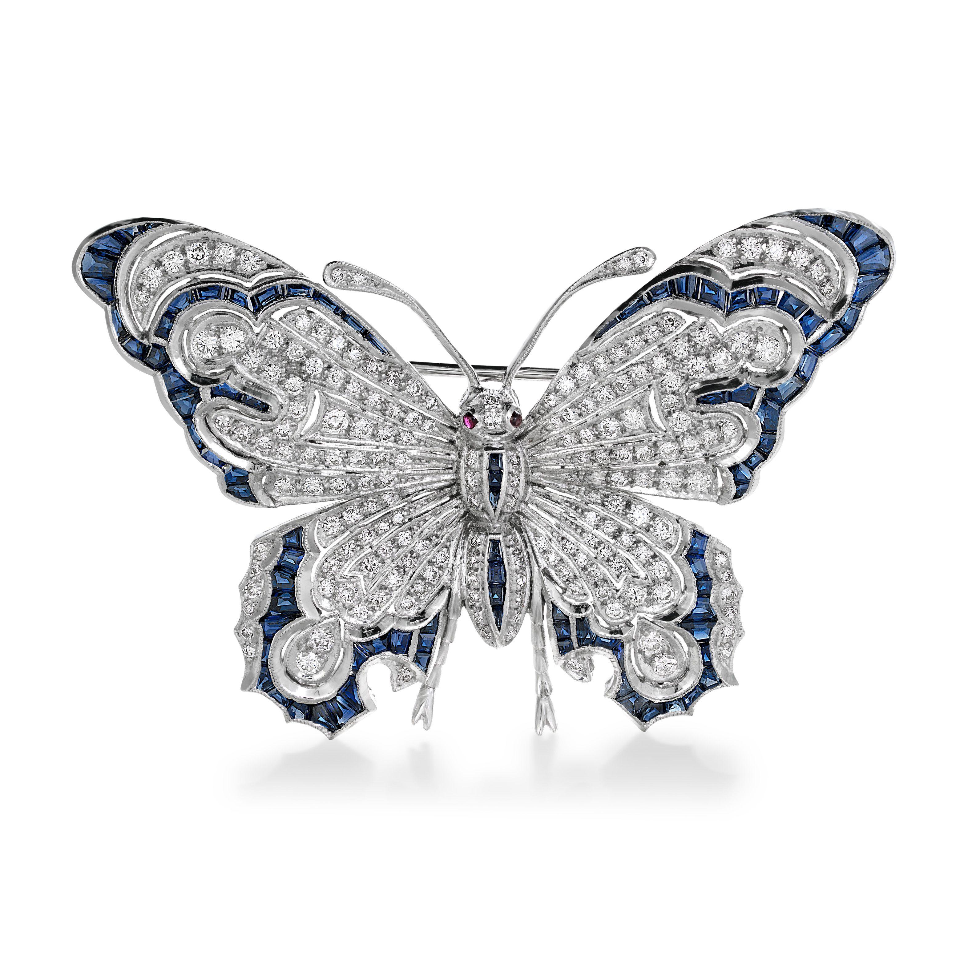 Simply Magnificent! Finely detailed Blue Sapphire and Diamond Art Deco Revival Butterfly Brooch. Hand set with 95 Calibrated Baguette Blue Sapphires, approx. 3.30tcw and 182 Brilliant-cut Diamonds, approx. 1.84tcw with 2 Cabochon Rubies eyes. Total