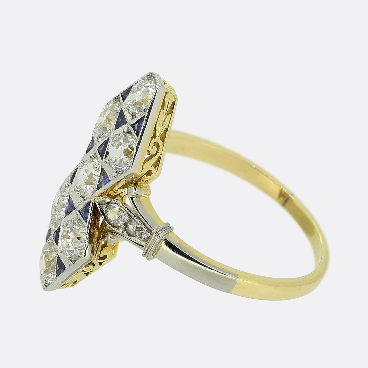 Here we have a marvellous navette ring taken from the pinnacle of the Art Deco movement. This elegant piece showcases a geometric design consisting of seven round faceted old cut diamonds with twelve perfectly matched triangular shaped calibre cut