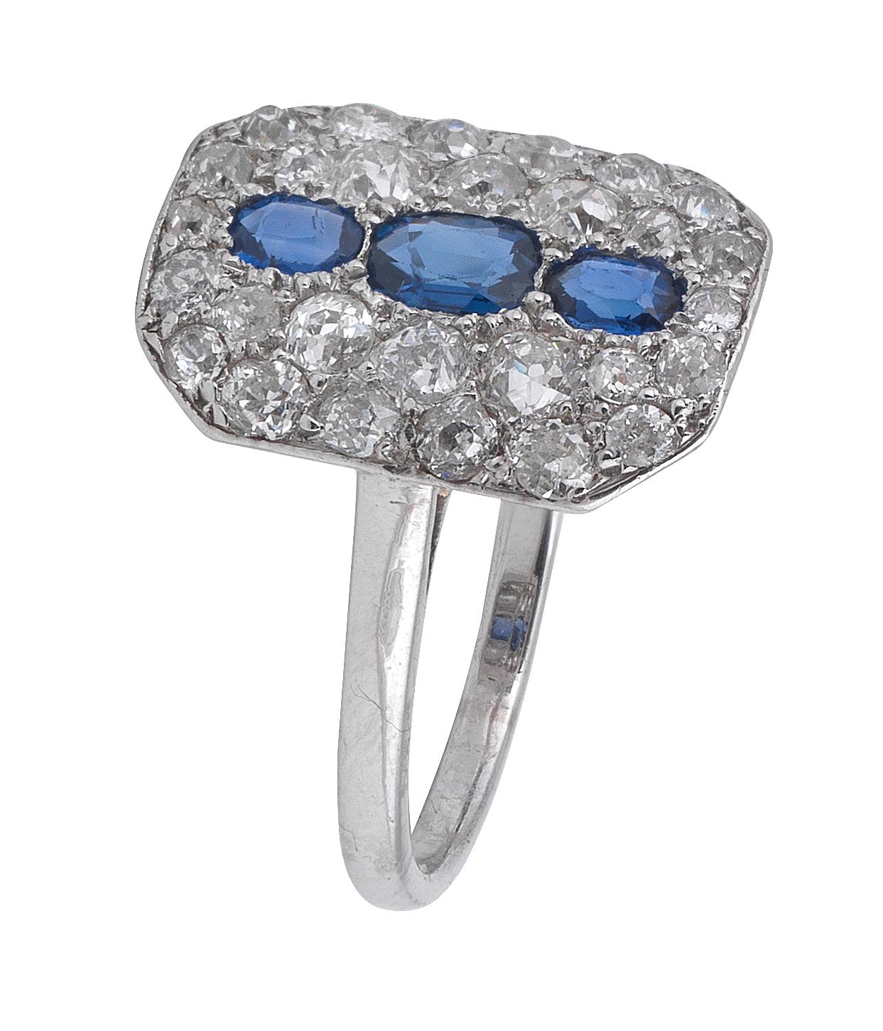 The central row of cushion cut sapphires within old brilliant-cut diamond surround, Mounted in Platinum, diamonds approx. 1.15ct. total, ring size 7