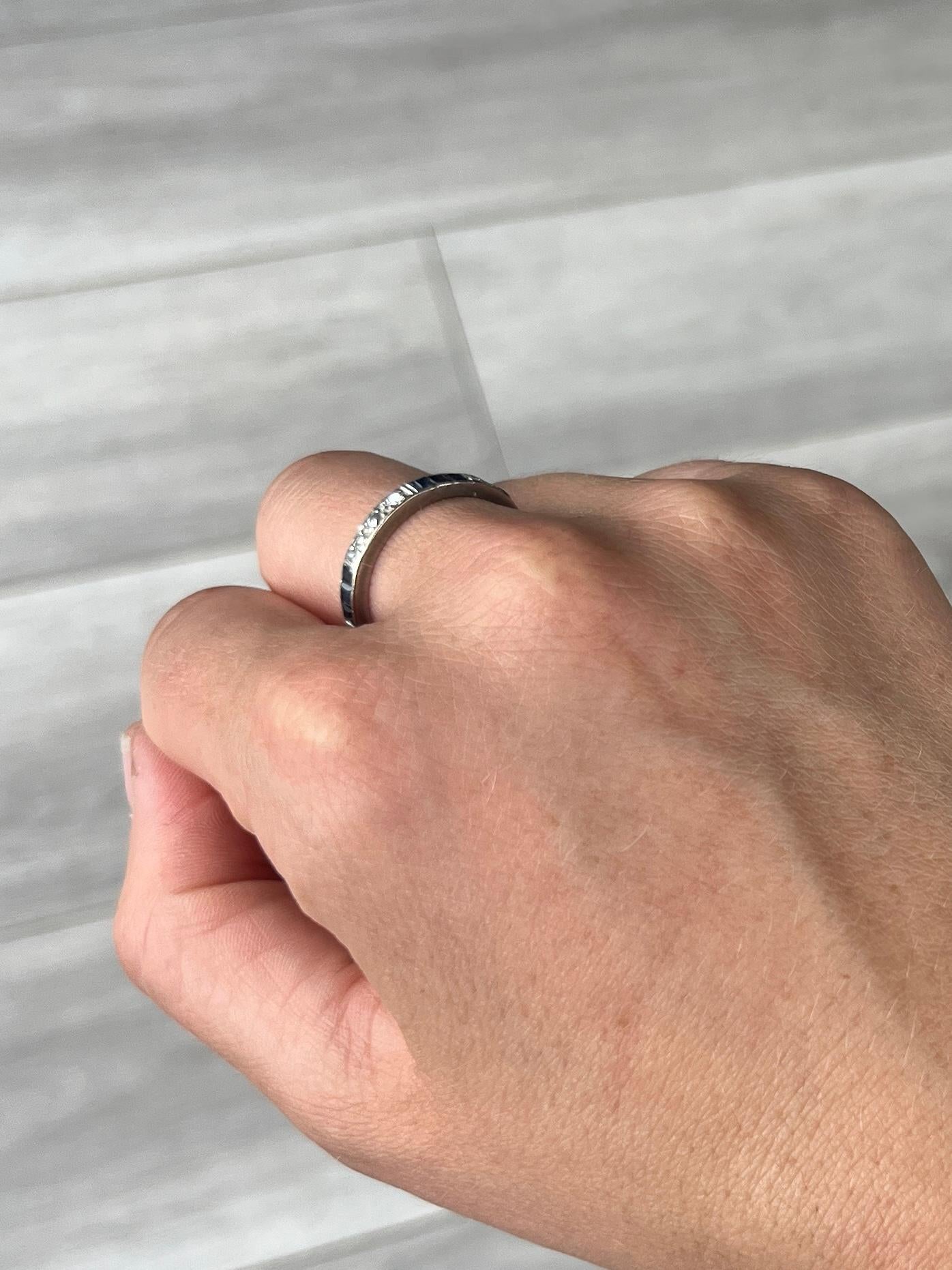This sweet diamond and blue sapphire eternity has the stones set within the band. The stones are grouped in collections of three diamonds and three sapphires. The diamonds measure approx 4pts each and the sapphires measure approx 5pts each. 

Ring