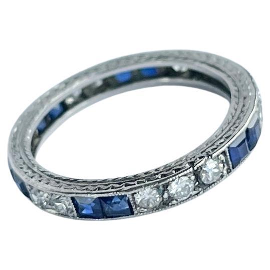 This sweet diamond and blue sapphire eternity has the stones set within the band. The stones are grouped in collections of two diamonds and two sapphires (apart from one collection of three). The diamonds measure approx 3pts each and the sapphires