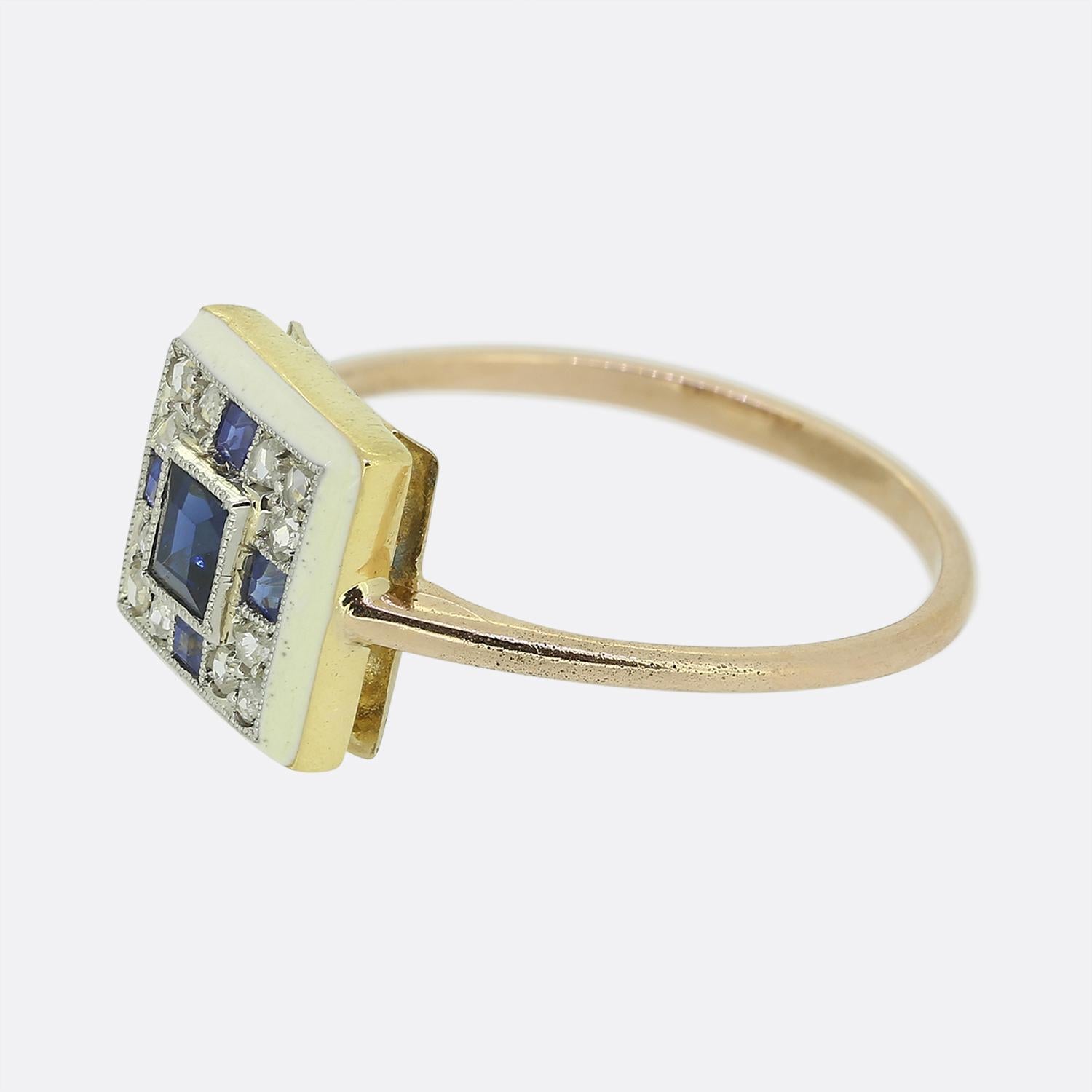 Here we have a wonderful cluster ring crafted at a time when the Art Deco style was at the forefront of design. A square shaped head plays host to square shaped sapphire at the centre of the face. This principal stone possesses a rich navy blue