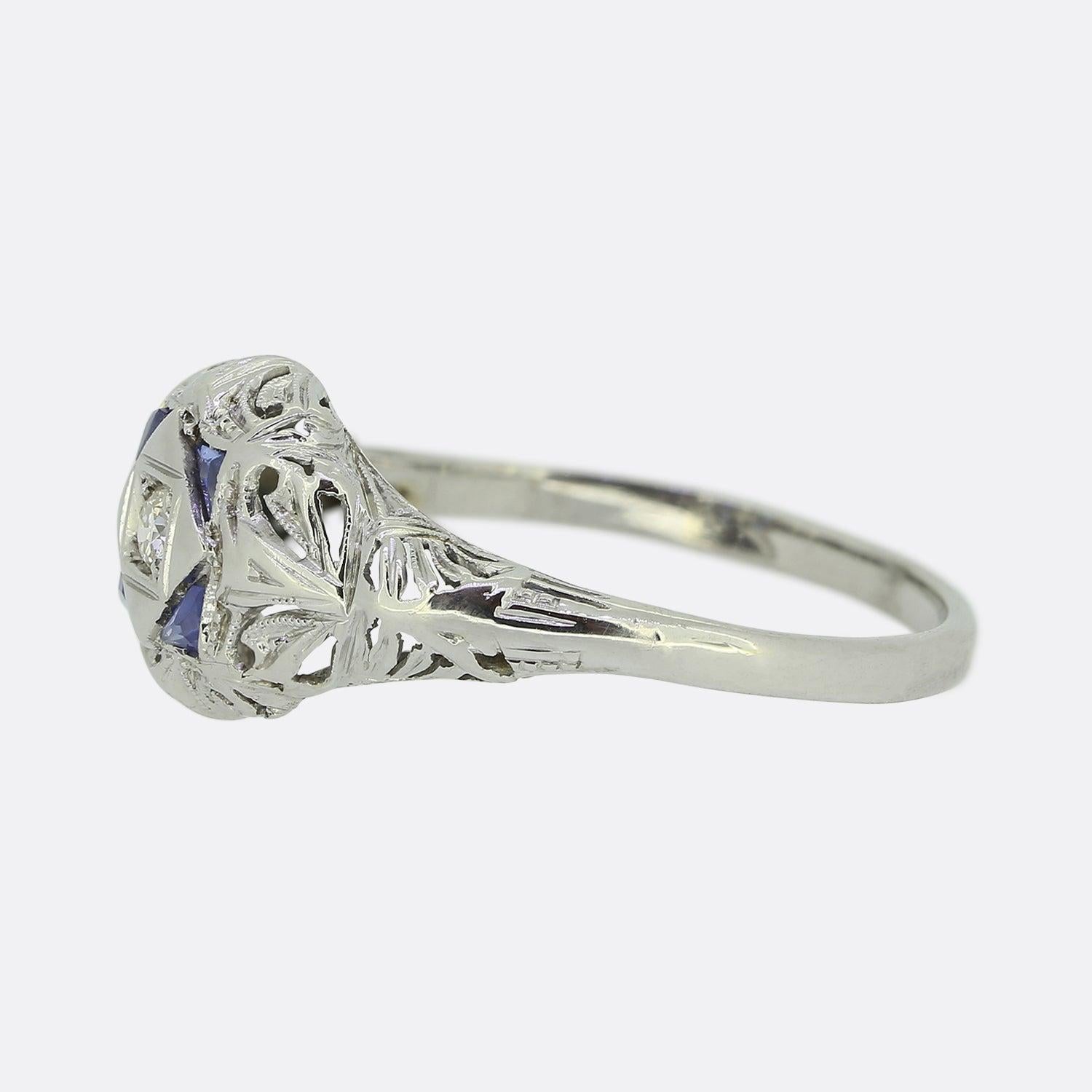 This is a delightful Art Deco sapphire and diamond ring. Crafted from 18ct white gold, this piece showcases many of the typical features associated with the style including meticulously handcrafted open pierced work and the sleek geometric designs.