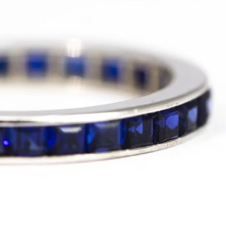 This stunning deep blue stone encrusted eternity band holds sapphires that measure 5pts each and are set flush in a gorgeous glossy platinum band.

Ring Size: J 1/2 or 5 
Band Width: 2.5mm

Weight: 1.5g