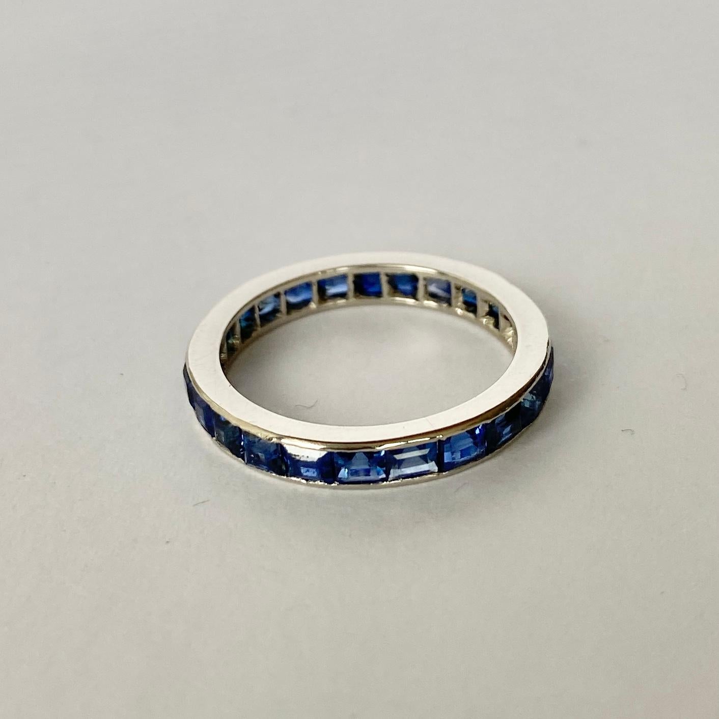 The gorgeous eternity band holds gorgeous square cut sapphires. The stones are set within a smooth platinum band. 

Ring Size: N or 6 3/4 
Band Width: 3mm

Weight: 3.3g