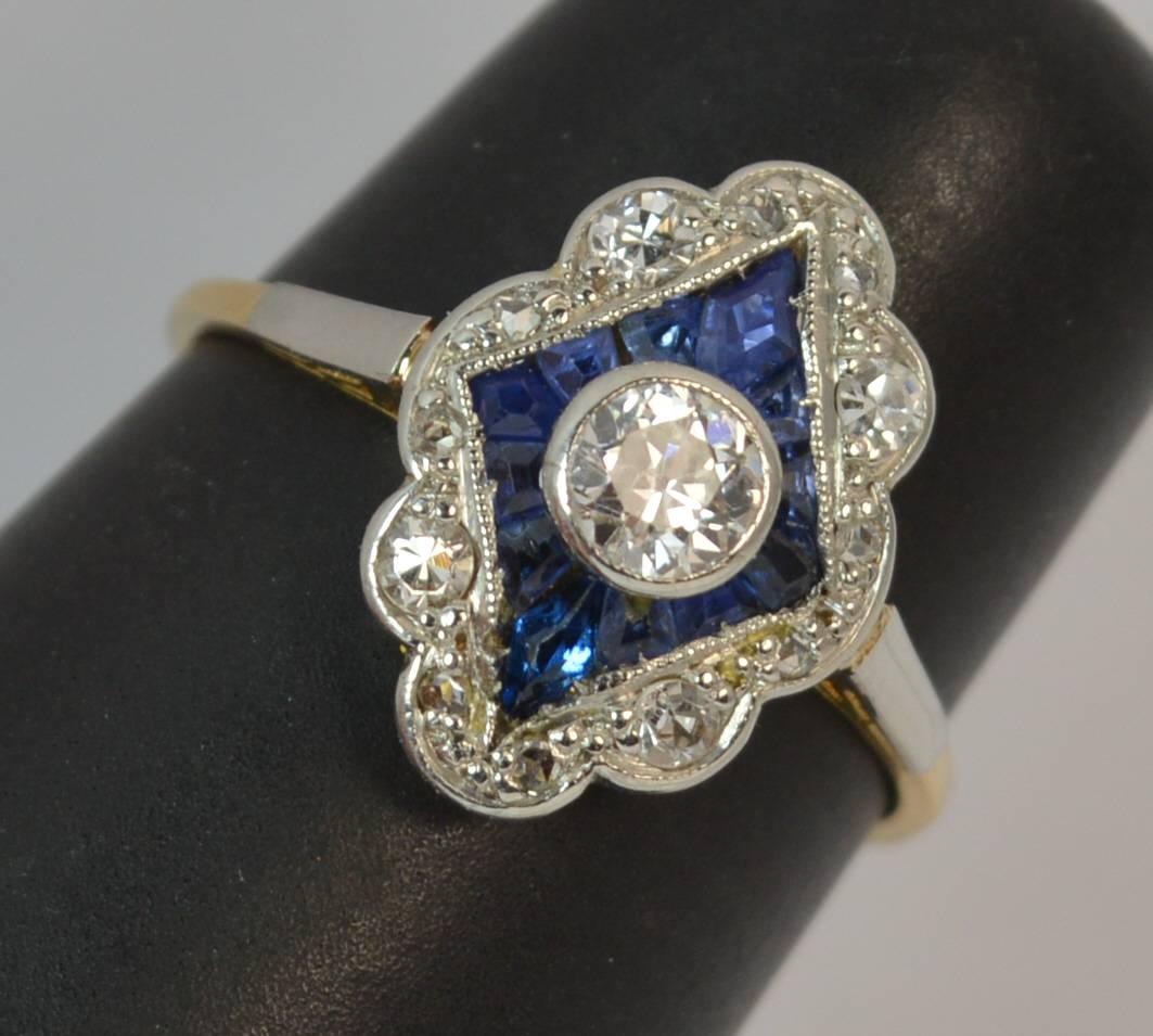 
A fantastic Sapphire and Diamond panel cluster ring.

Solid 18 carat gold example with a platinum head.

​The cluster is designed with a natural old cut diamond to the centre, 4mm diameter in a collet mount. Surrounding the diamond are 12 uniquely
