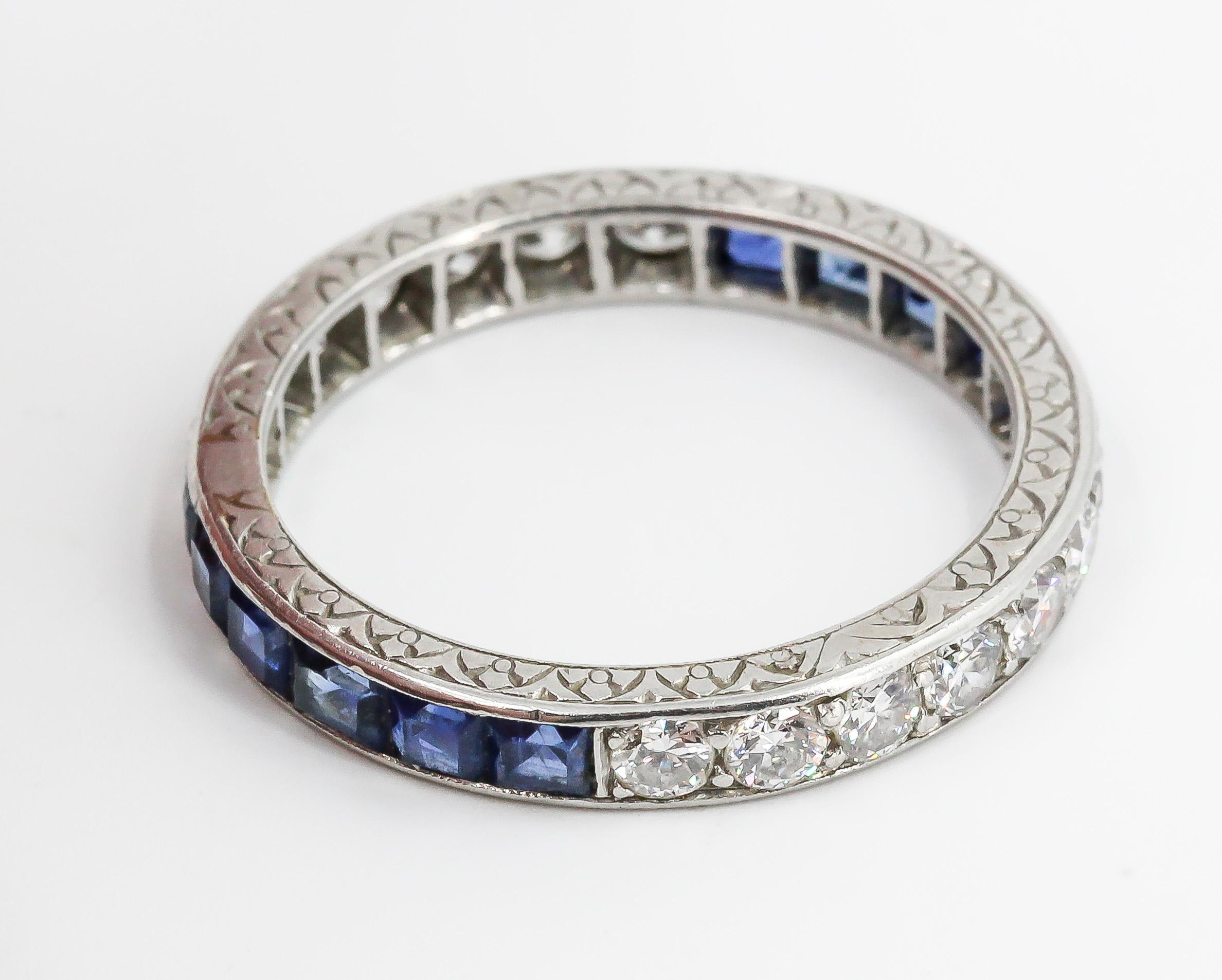 Chic sapphire, diamond and platinum large band, circa 1920s. It features rich blue sapphires and high grade round brilliant cut diamonds. US size 9.

