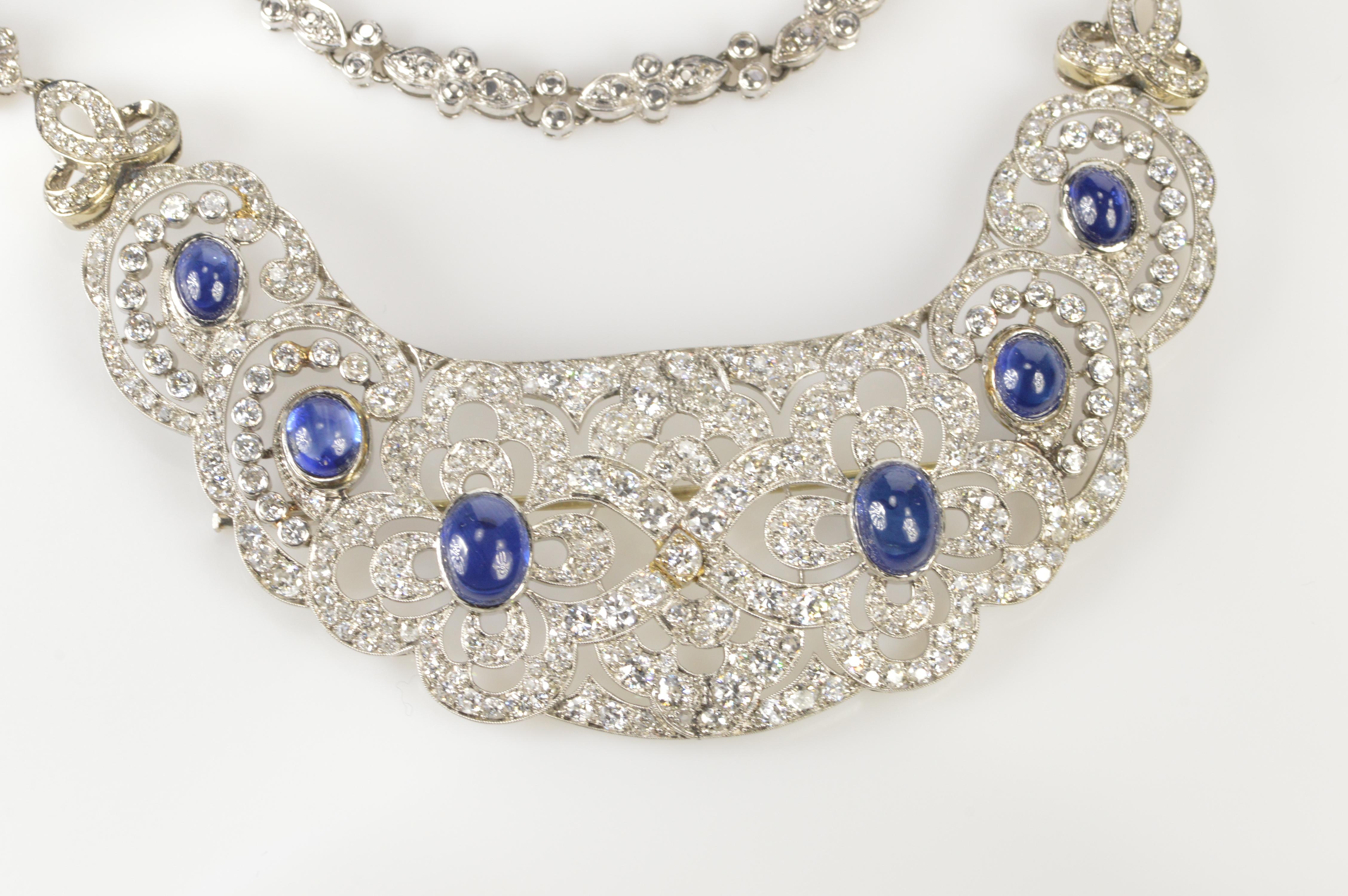 This beautiful “bib” style necklace was most likely a hair comb or hair piece that was at some point was altered by adding a custom styled chain. The base of the necklace is a fantastically styled Art Deco platinum piece with cabochon sapphires and