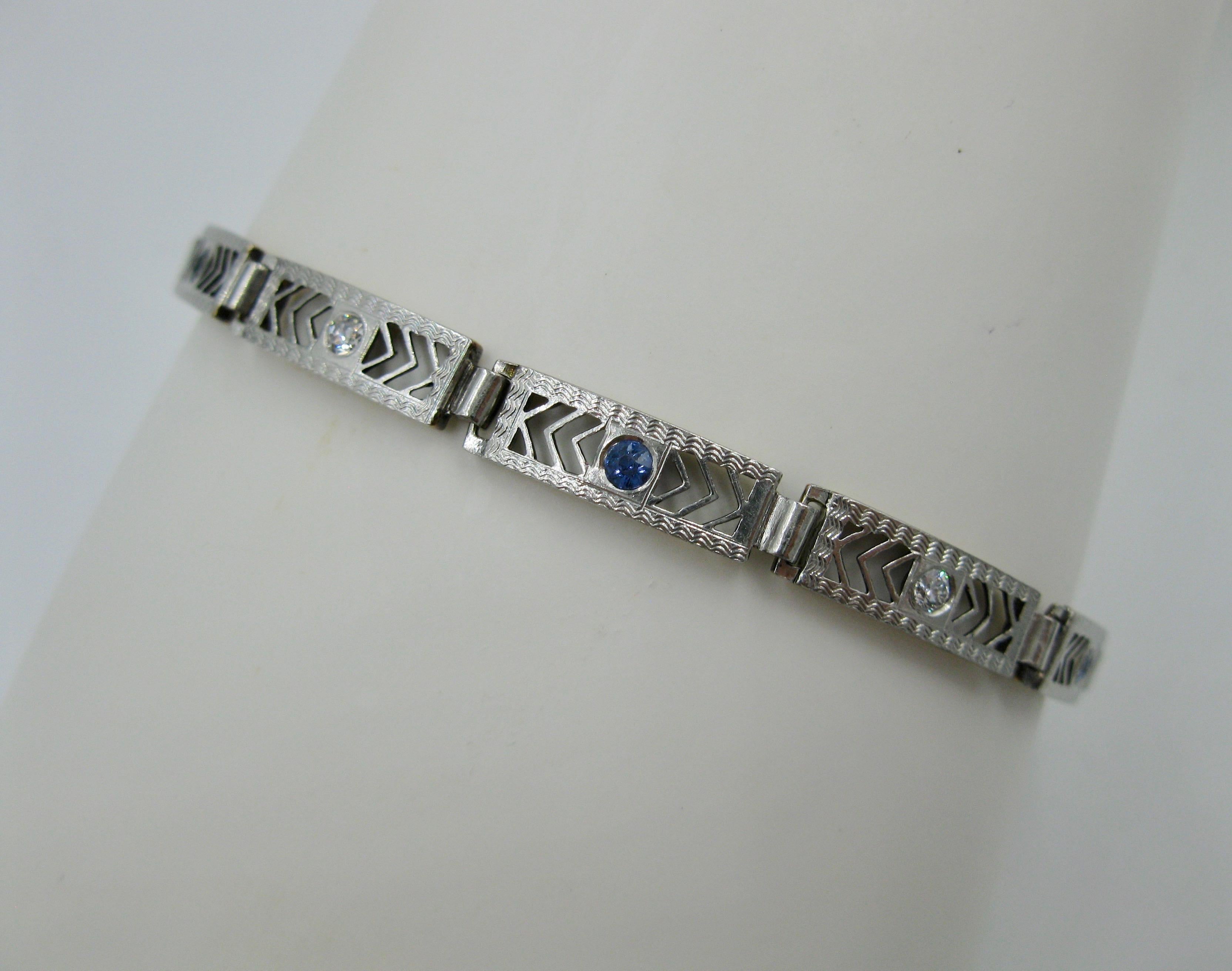 A stunning Art Deco - Edwardian Diamond Sapphire Bracelet in 14 Karat White Gold.  The open work link medallions are gorgeous.  They are set with three fine blue natural sapphires of great color along with two brilliant white antique Old Mine Cut