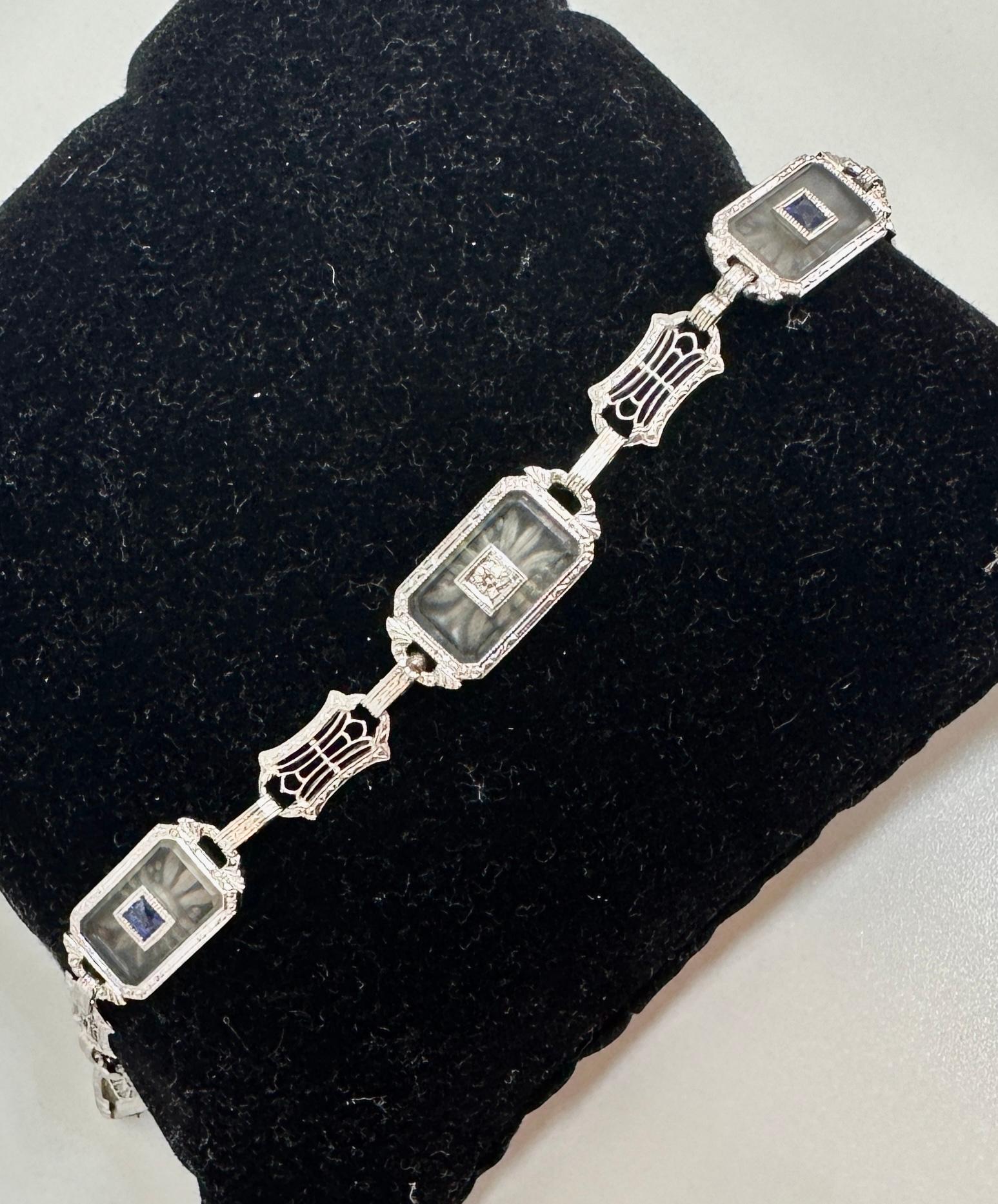 This is a radiant Sapphire and Old Mine Cut Diamond Frosted Rock Crystal 18 Karat White Gold Bracelet. The classic antique Art Deco bracelet of great beauty is set with rectangular carved Rock Crystal plaques. The three plaques are each pierced with