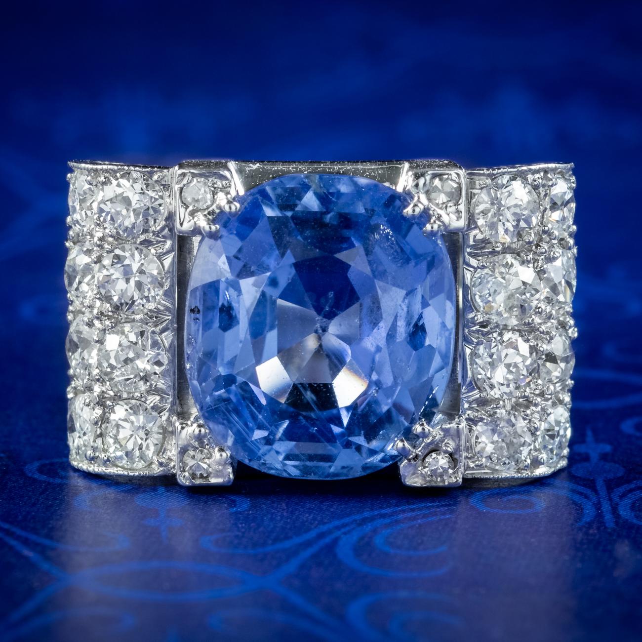  A magnificent Art Deco cocktail ring boasting a bed of sparkling diamonds with a breath-taking cushion cut blue sapphire in the centre weighing approx. 6 carats. It’s believed to have originated from Sri Lanka and has been tested as natural with no