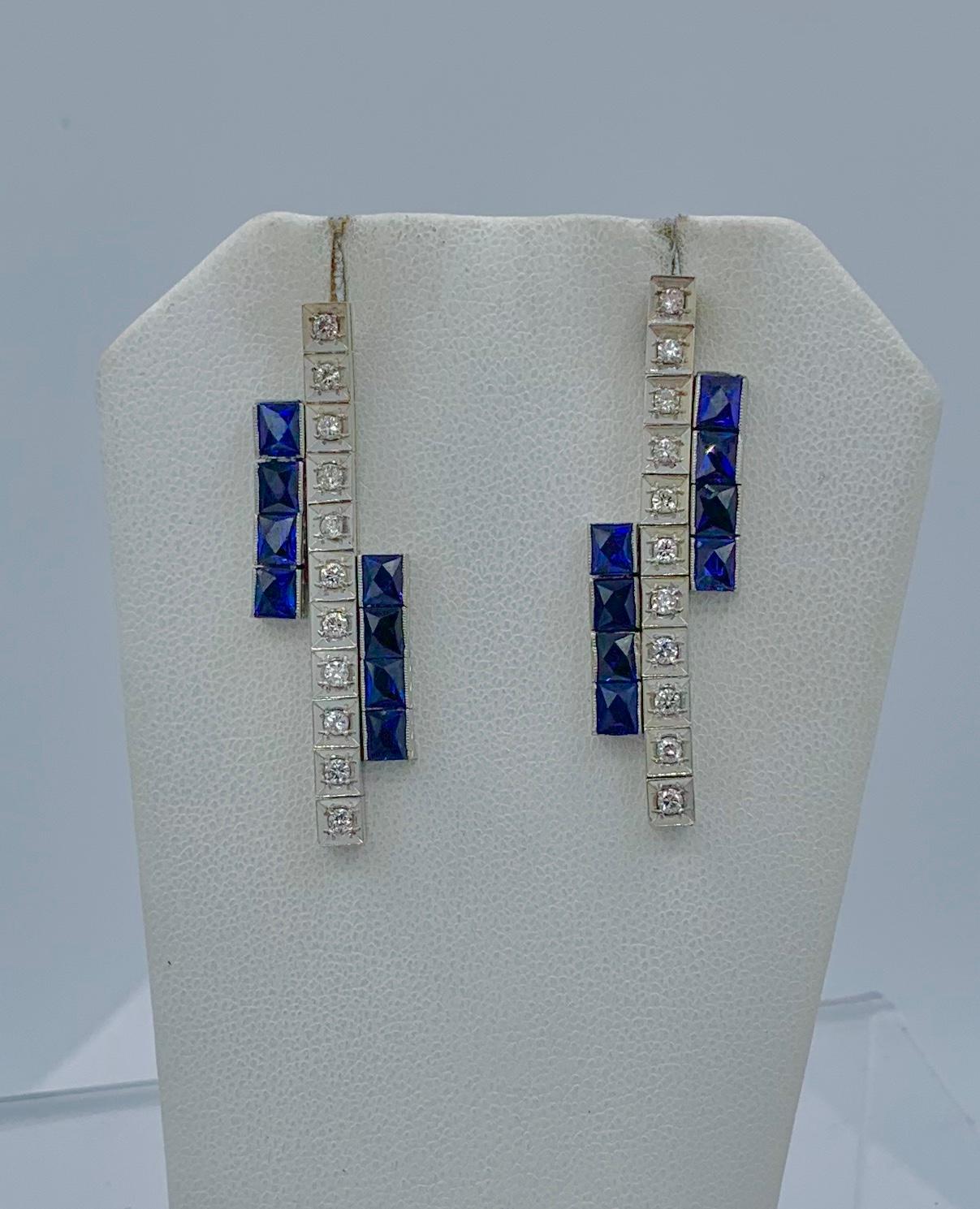 This is a stunning pair of Art Deco Sapphire and Diamond Dangle Drop Earrings in 14 Karat White Gold.  The fabulous earrings are articulated throughout so they dangle beautifully from the ear.  The earrings have 22 sparkling white diamonds set in