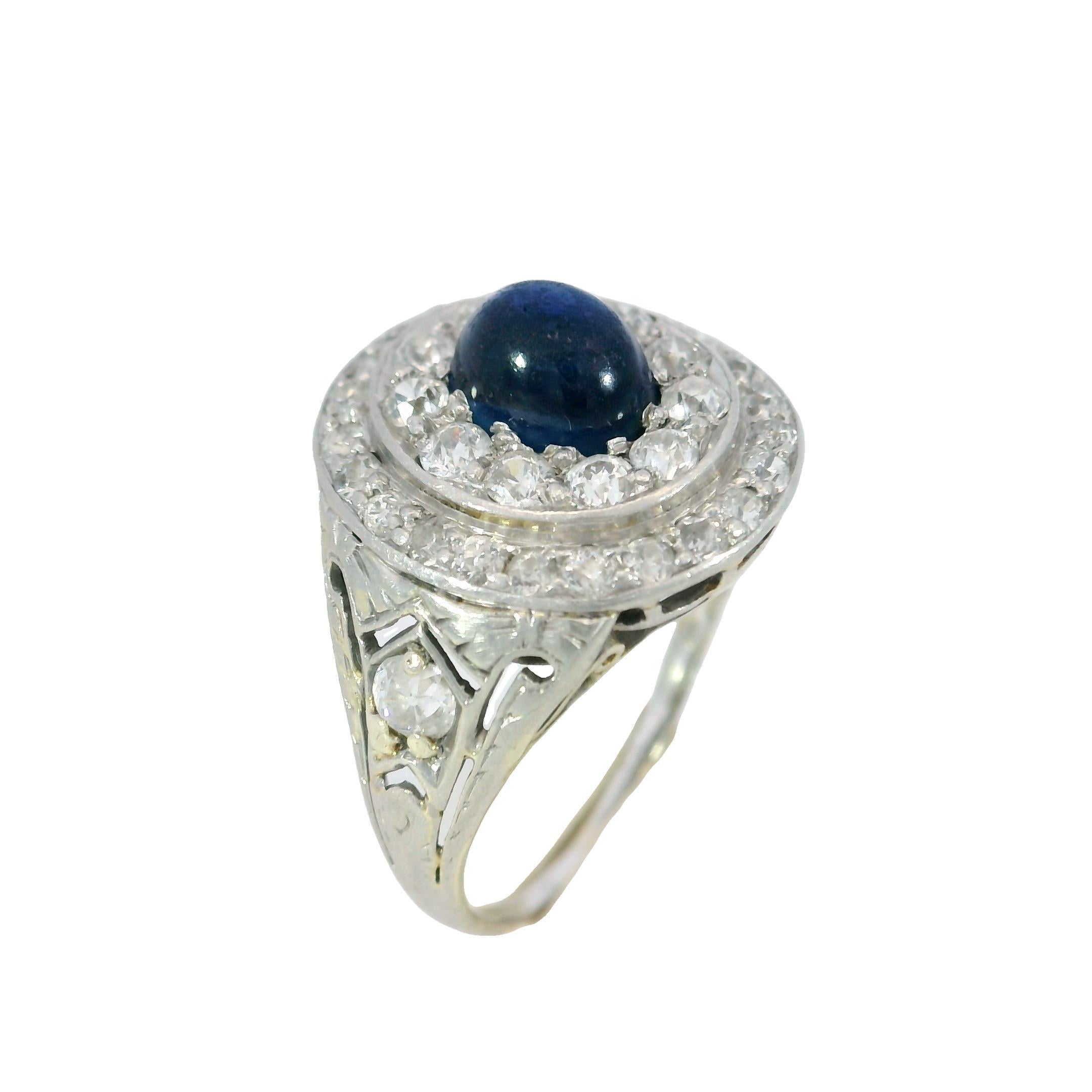 Art Deco Sapphire Diamond Double Halo Ring 14k Platinum ~2.11ctw

This original Art Deco ring centers on a ~1.38-carat cabochon-cut sapphire, its deep blue tone offering a quiet depth that reflects the period’s understated glamour. Surrounding the