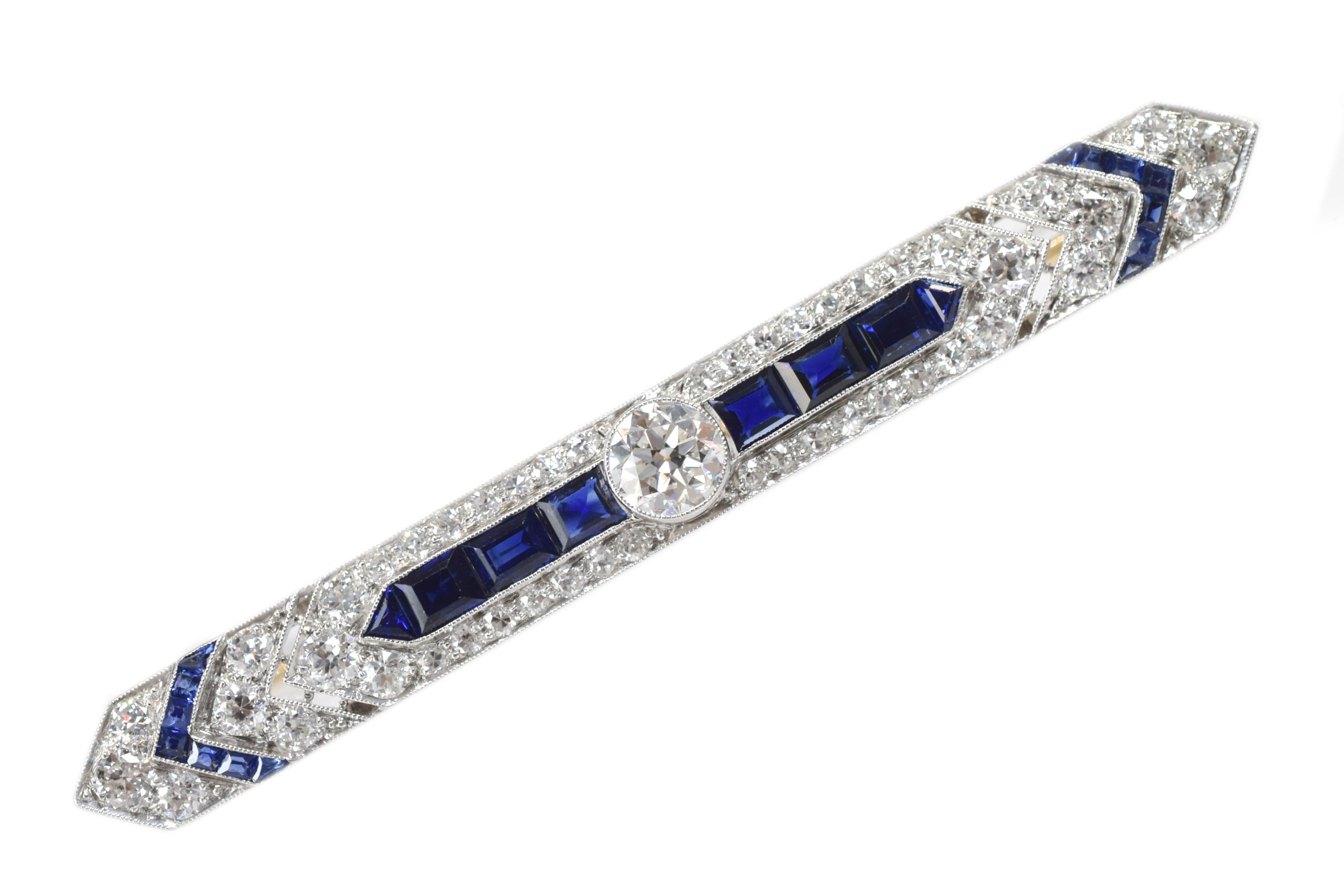 Art Deco Brooch! with millgrain accents,  the brooch has an impressive 1.0 carat Old European diamond in the center, 46 round-cut diamonds with an approximate total weight of 2.0 carats and 22 calibre-cut sapphires with an approximate total weight