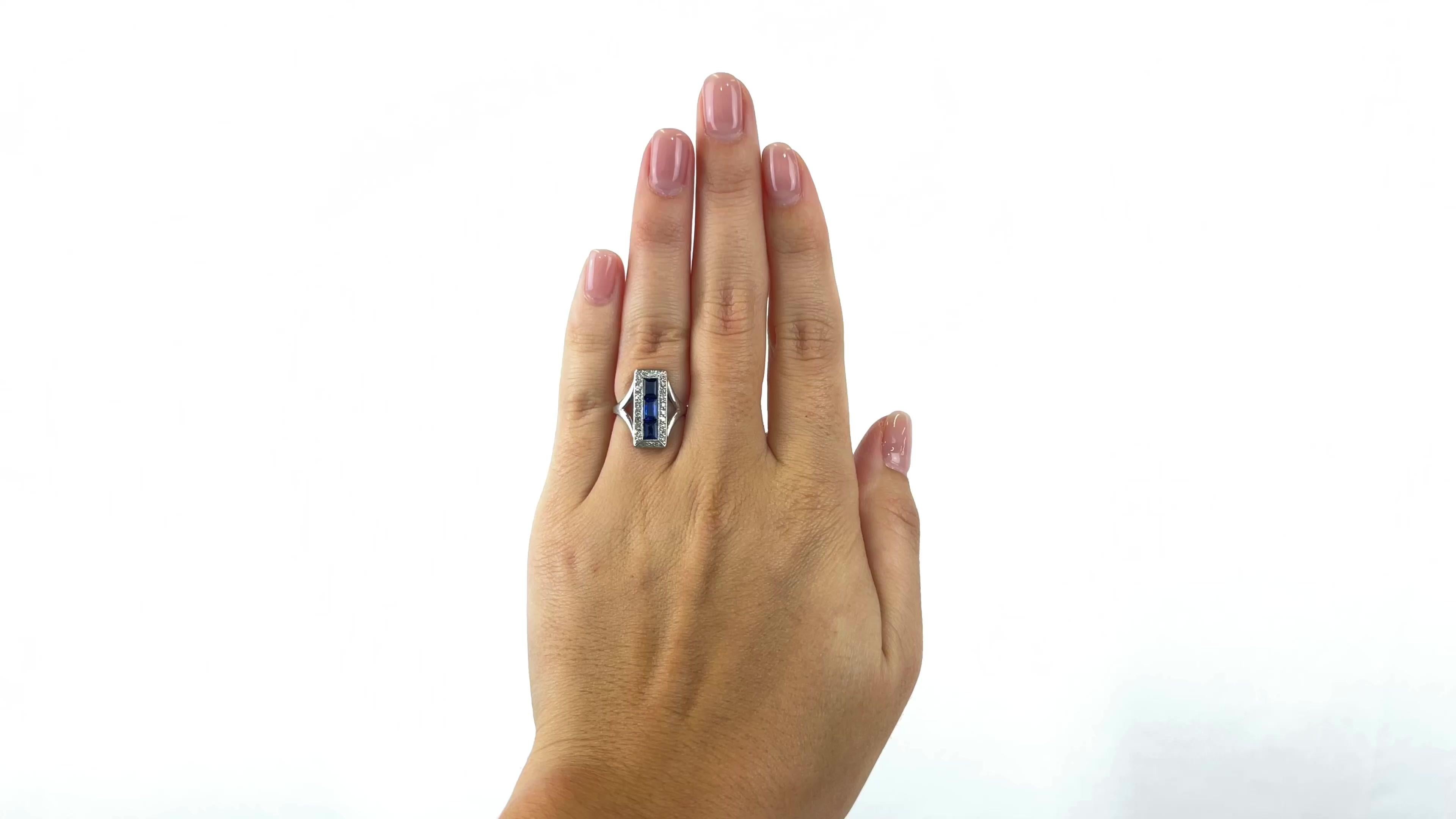 One Art Deco Sapphire Diamond Platinum Ring. Featuring three square cut sapphires with a total weight of approximately 0.81 carats. Accented by 26 single cut diamonds with a total weight of approximately 0.26 carats, graded G color, SI clarity.