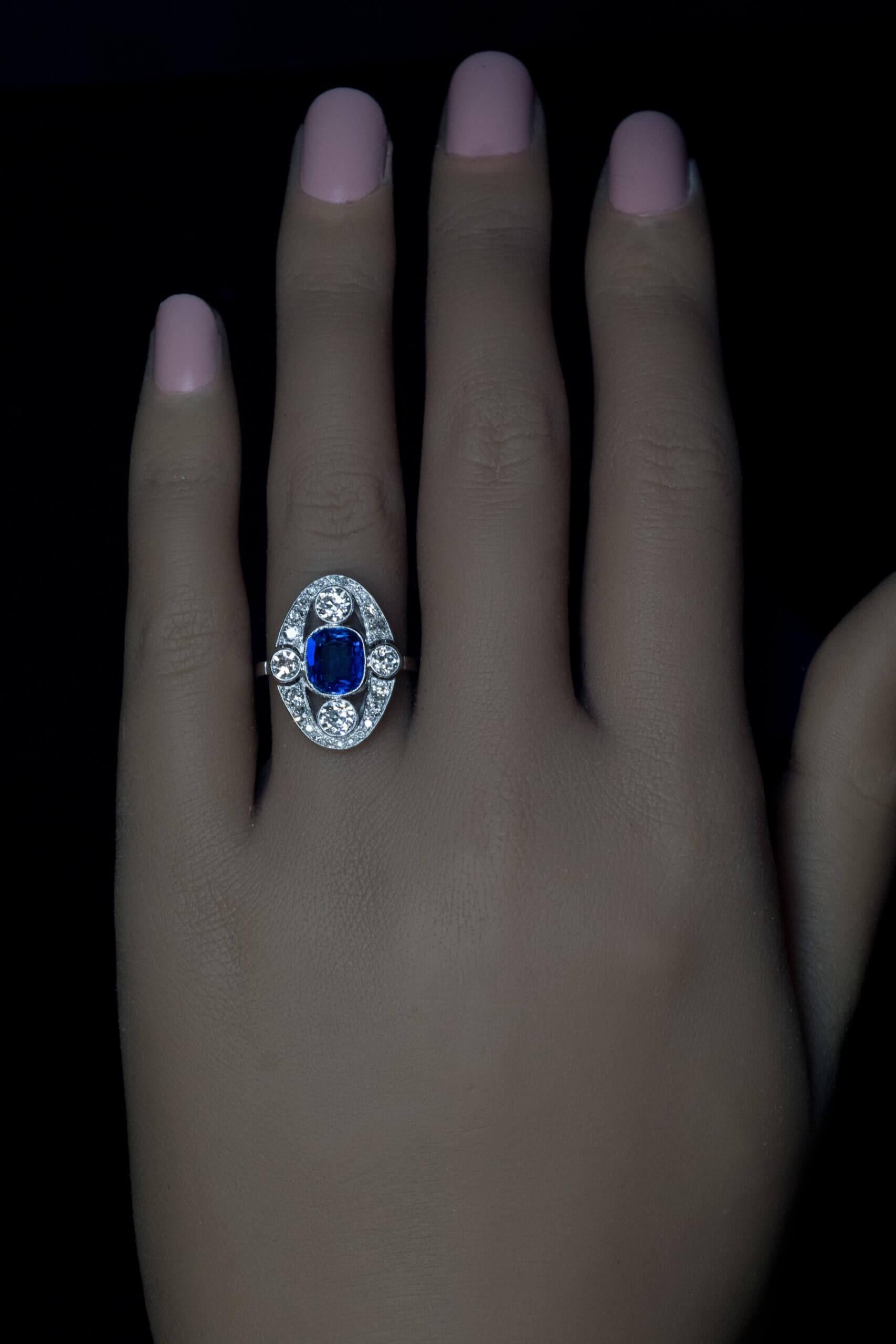 Circa 1920s  This Art Deco era platinum ring features a 1.92 carat natural unheated sapphire from Ceylon of beautiful royal blue color. The sapphire is framed by bright white old European and old mine cut diamonds (G-H color, VS1-VS2 clarity). 