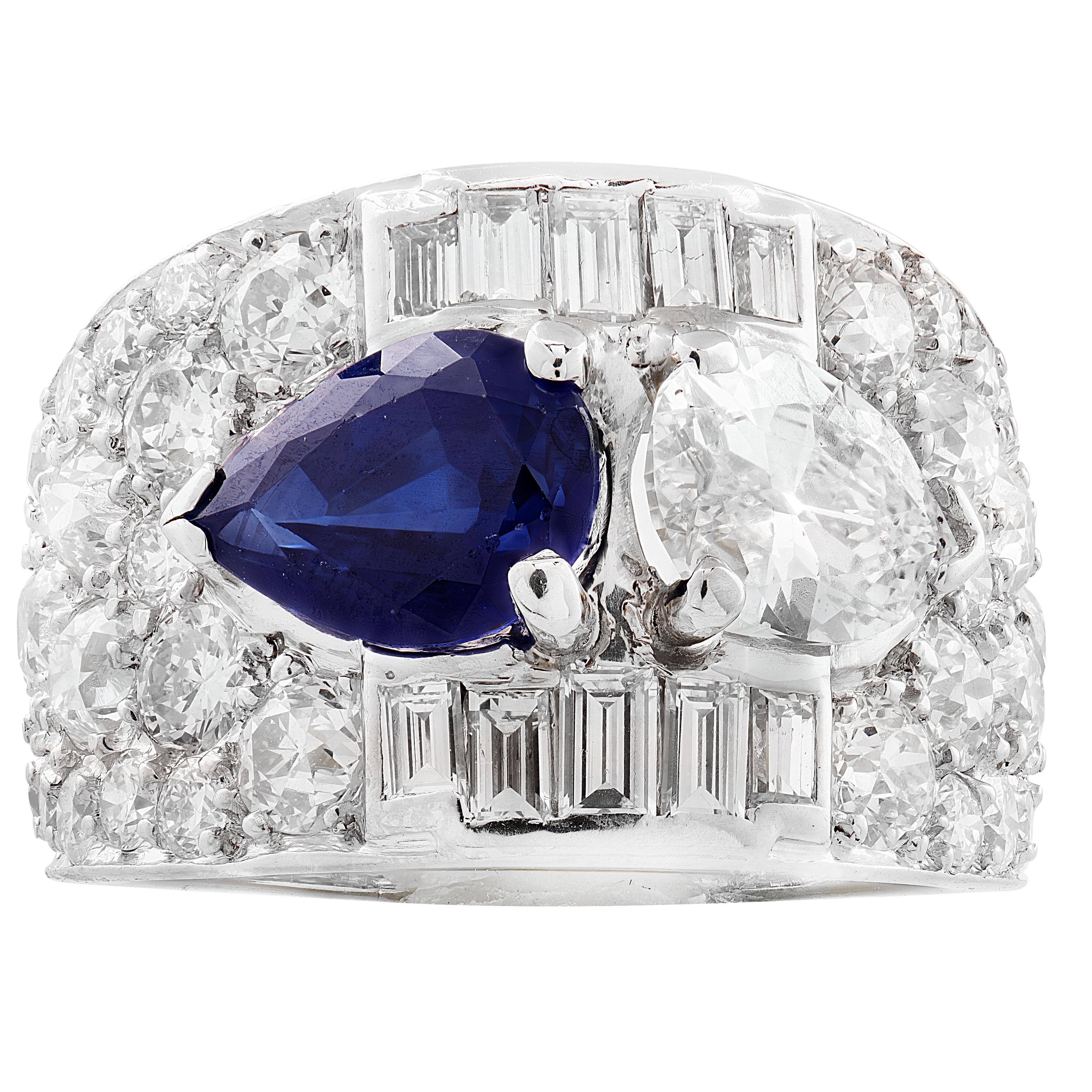 Delicately handcrafted in platinum circa 1930s, this enchanting ring centers on a luminous pear-shaped blue sapphire weighing approximately 1.80 carats. It is gracefully flanked by a pear-shaped diamond weighing approximately 0.90 carats, E color,