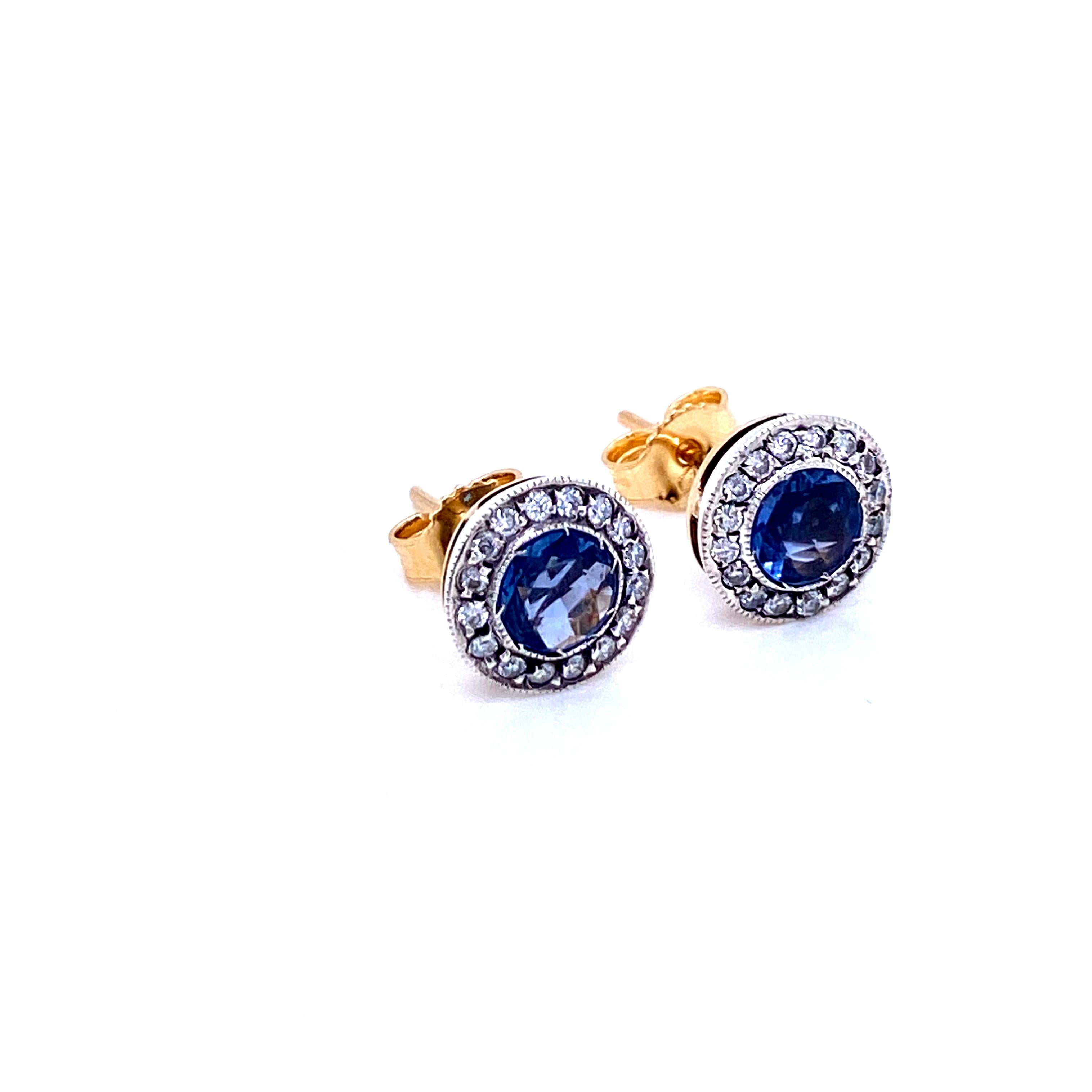 These exquisite stud earrings are adorned at the center with 2 Natural Sapphires. .50 ct. each and surrounded by round cut Diamond having a total weight of .36 carats. Handcrafted in 18k yellow Gold and silver. Circa 1930

CONDITION: Pre-owned -