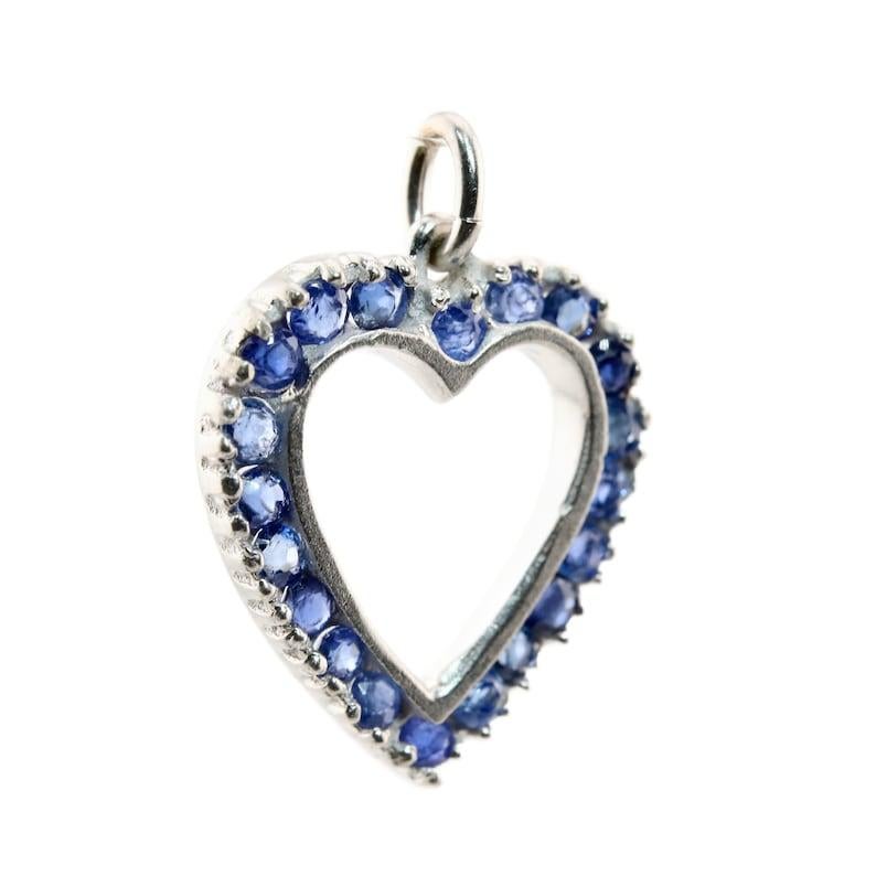 Aston Estate Jewelry Presents:

An Art Deco period sapphire set heart charm pendant in platinum. Set with 20 sapphires of 1.00ctw with beautiful vivid cornflower blue color.

Tests as Platinum.

Measurements: 3/4