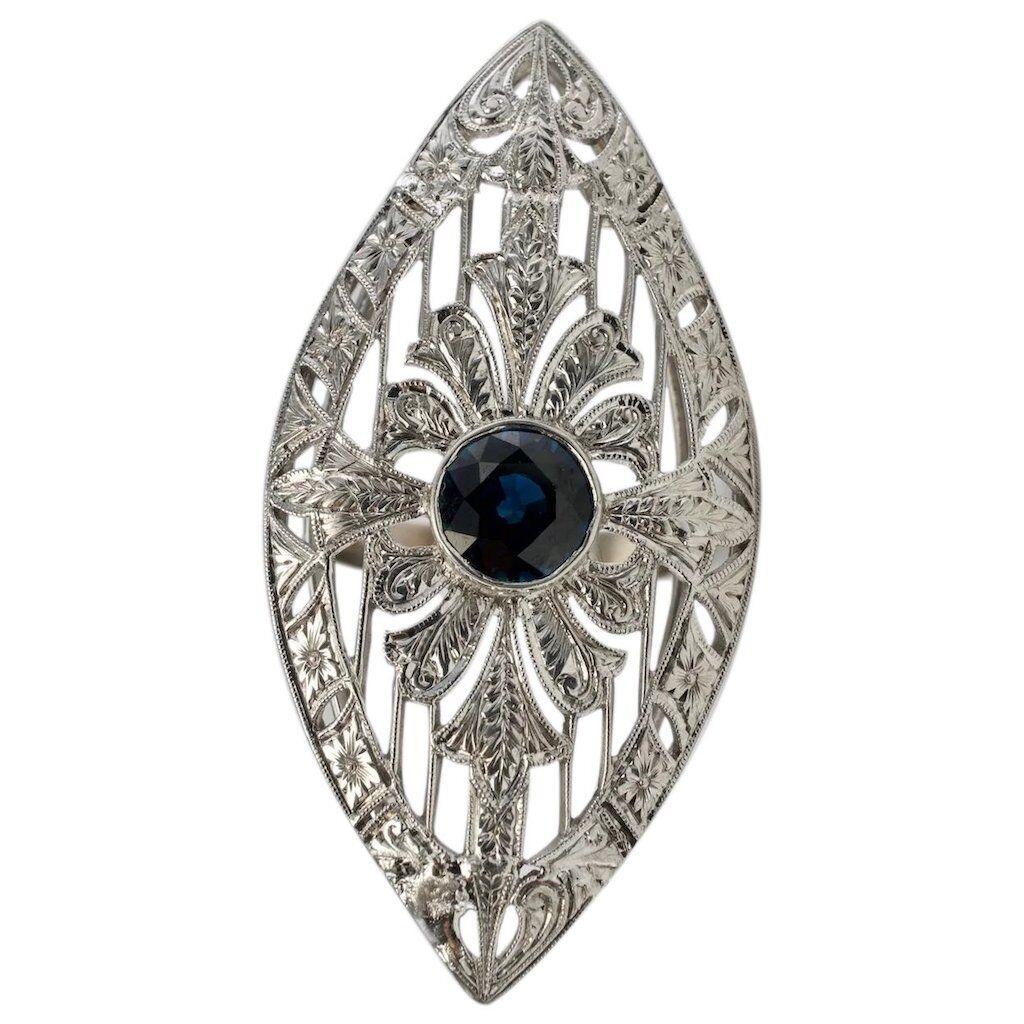 This spectacular vintage ring is finely crafted in luxurious 18K White Gold for the top and solid 14K White Gold (carefully tested and guaranteed). The center round cut natural Earth mined Sapphire is 7mm (1.60 carats). This is a nice quality stone