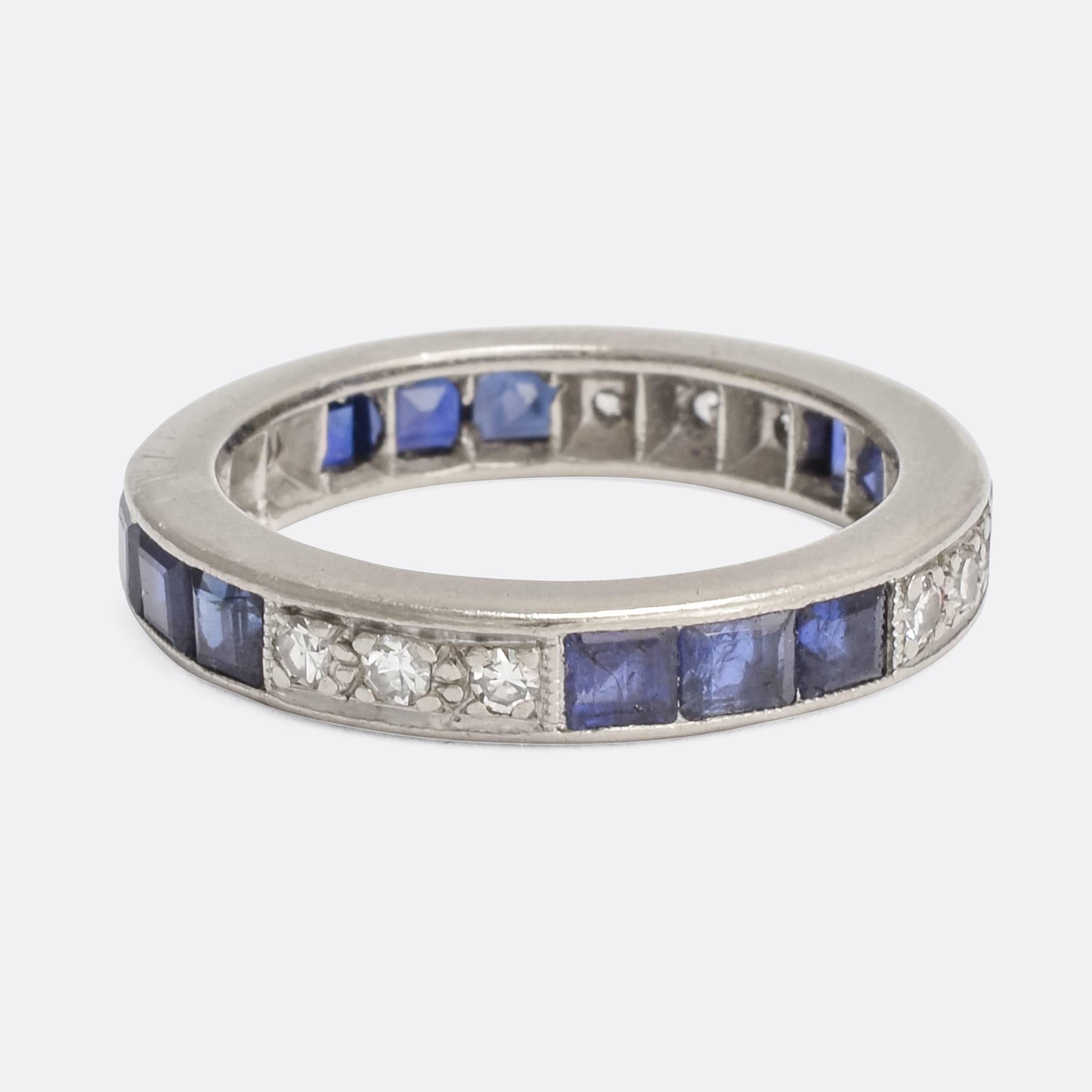 A classic Art Deco eternity ring, set with alternating sections of blue sapphire and white diamonds. It's modelled in platinum throughout; a good size with a substantial feel. A versitile piece, it could be worn as a wedding band with engagement