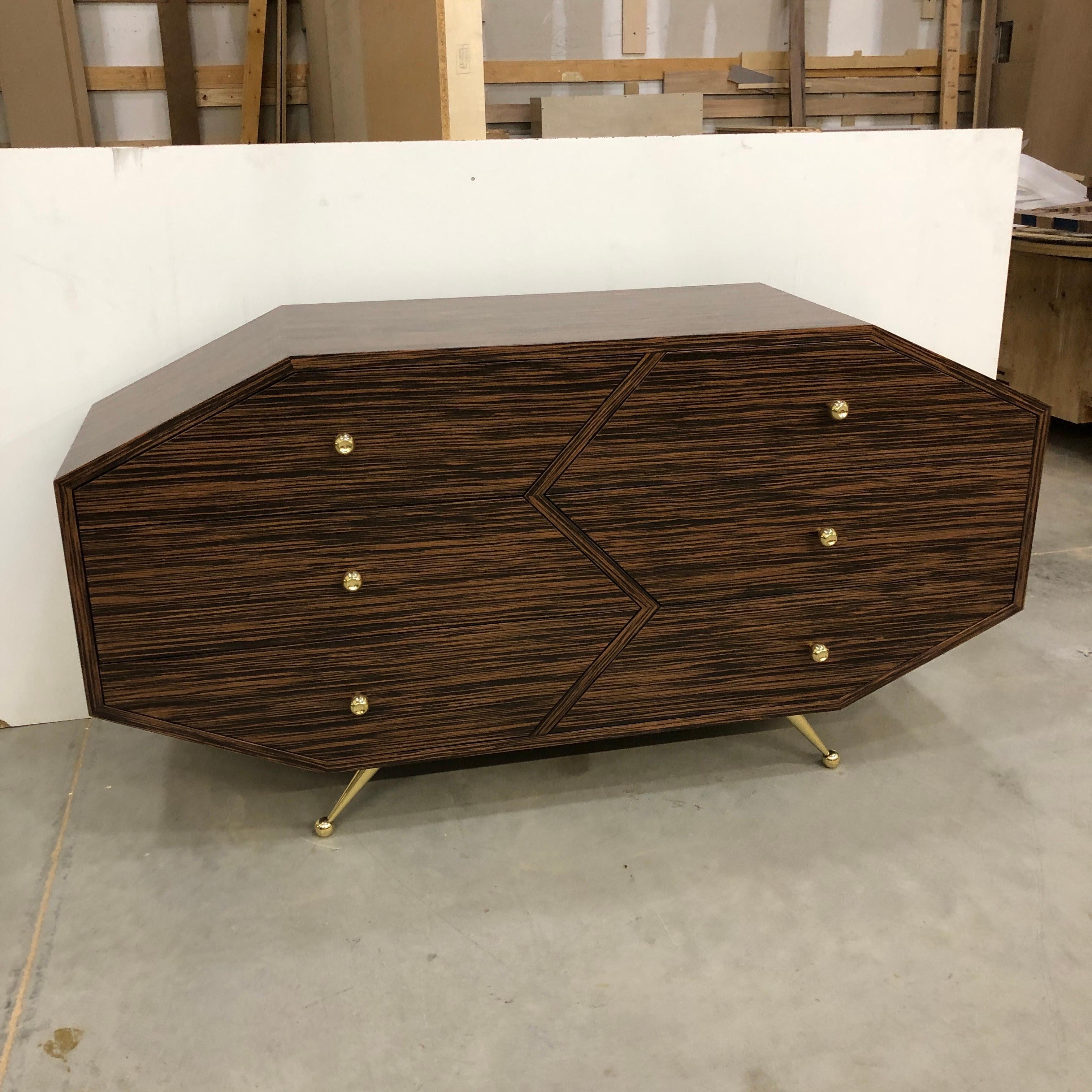 The BB10 sideboard/dresser has an Art Deco feel with a contemporary touch and is designed and hand-built by Troy Smith Studio. 

The exterior is veneered in Macassar Ebony and finished in a clear satin coat. All hardware, including feet and knobs,