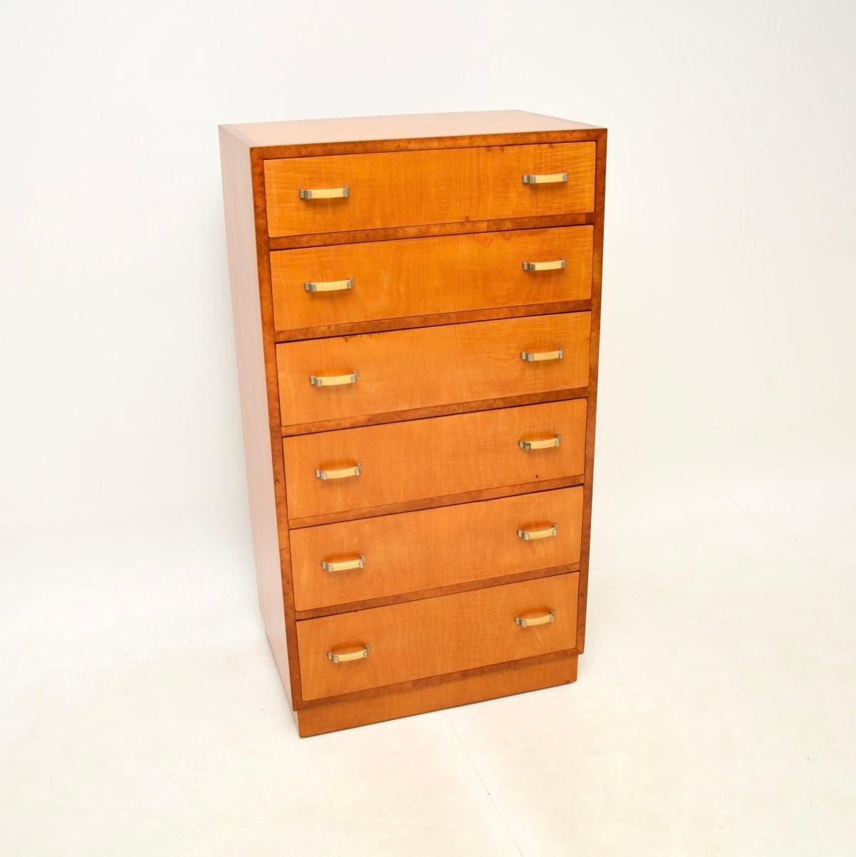 A superb Art Deco satinwood and walnut chest of drawers, this was made in England and dates from the 1930’s.

It is a great size and is of lovely quality. This is tall and slim, there is lots of storage inside the generous drawers. It sits on a