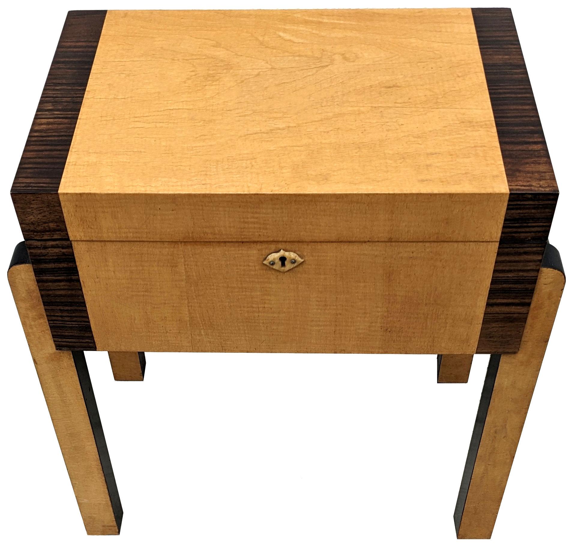 For your consideration is this delightful and superb stylish Art Deco work box table. Originating from England and dating to the 1930's is this lockable work table made from Blonde Satinwood with walnut feather banding and ebonized edging.