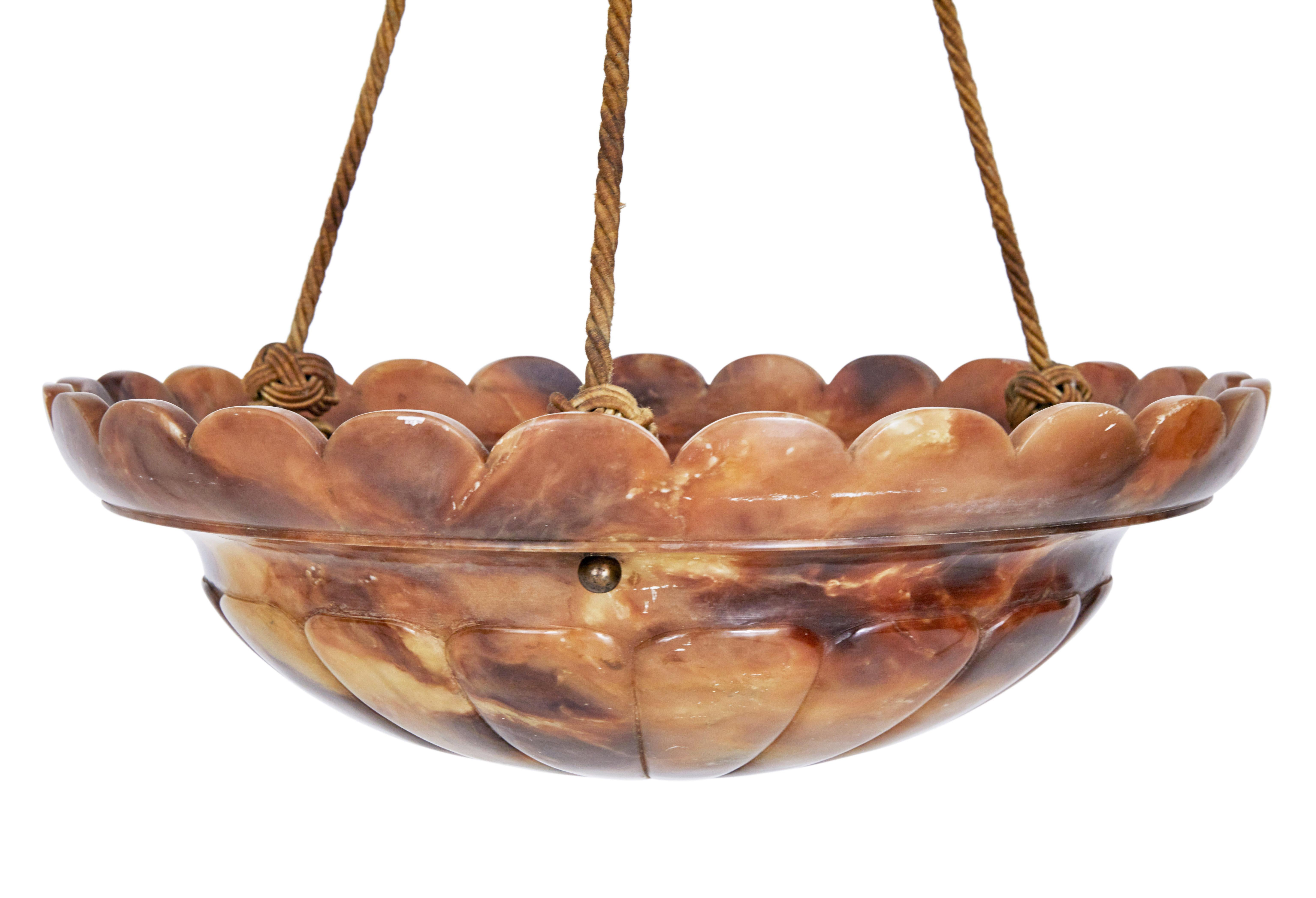 Good quality Art Deco alabaster ceiling light, circa 1930.

Carved scalloped shaping to top edge with carving to bottom of bowl. Supported by 3 ropes that lead up to a further alabaster ceiling rose.

Fitted with 3 screw in bulb light fittings.