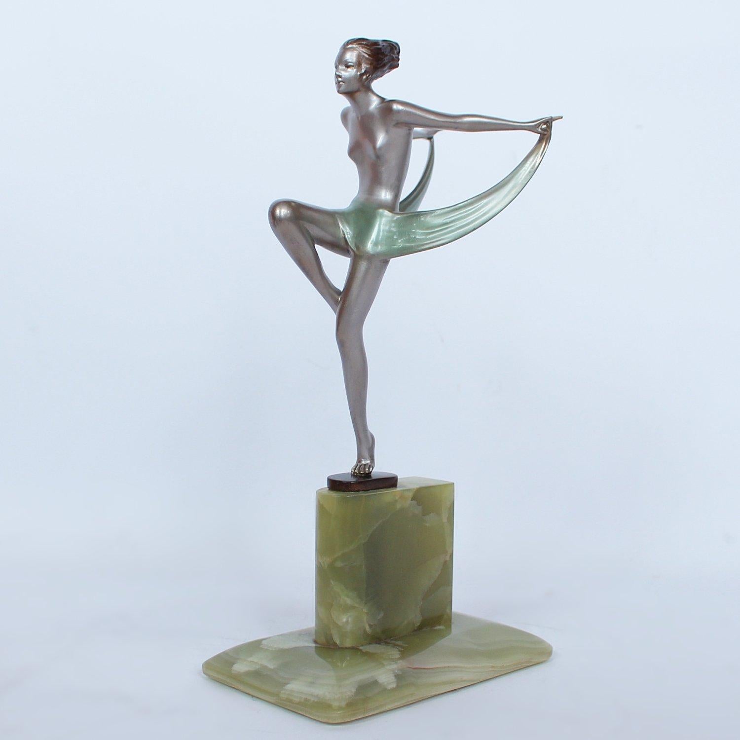 An Art Deco, silvered and cold painted bronze figure of a young lady in stylised pose. Set over a shaped plinth of green onyx. Signed Lorenzl to cast.

Artist: Josef Lorenzl (1892-1950).



 
