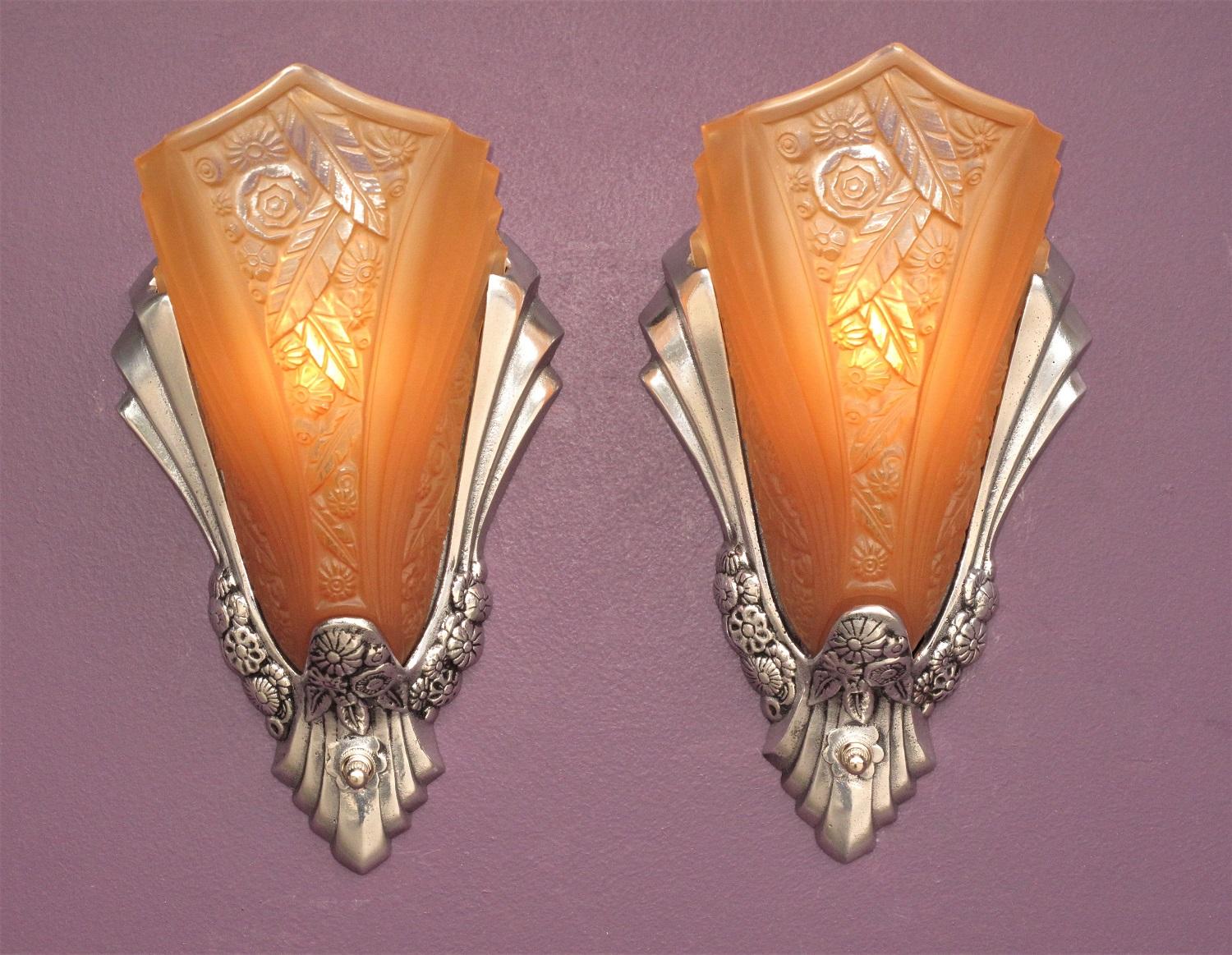 Priced per pair with 2 pair available.
Wonderful Art Deco era slip shade wall sconces with original patterned shades.
Aluminum frame has been restored to its high luster finish with the deco inspired floral design along the bottom highlighted with