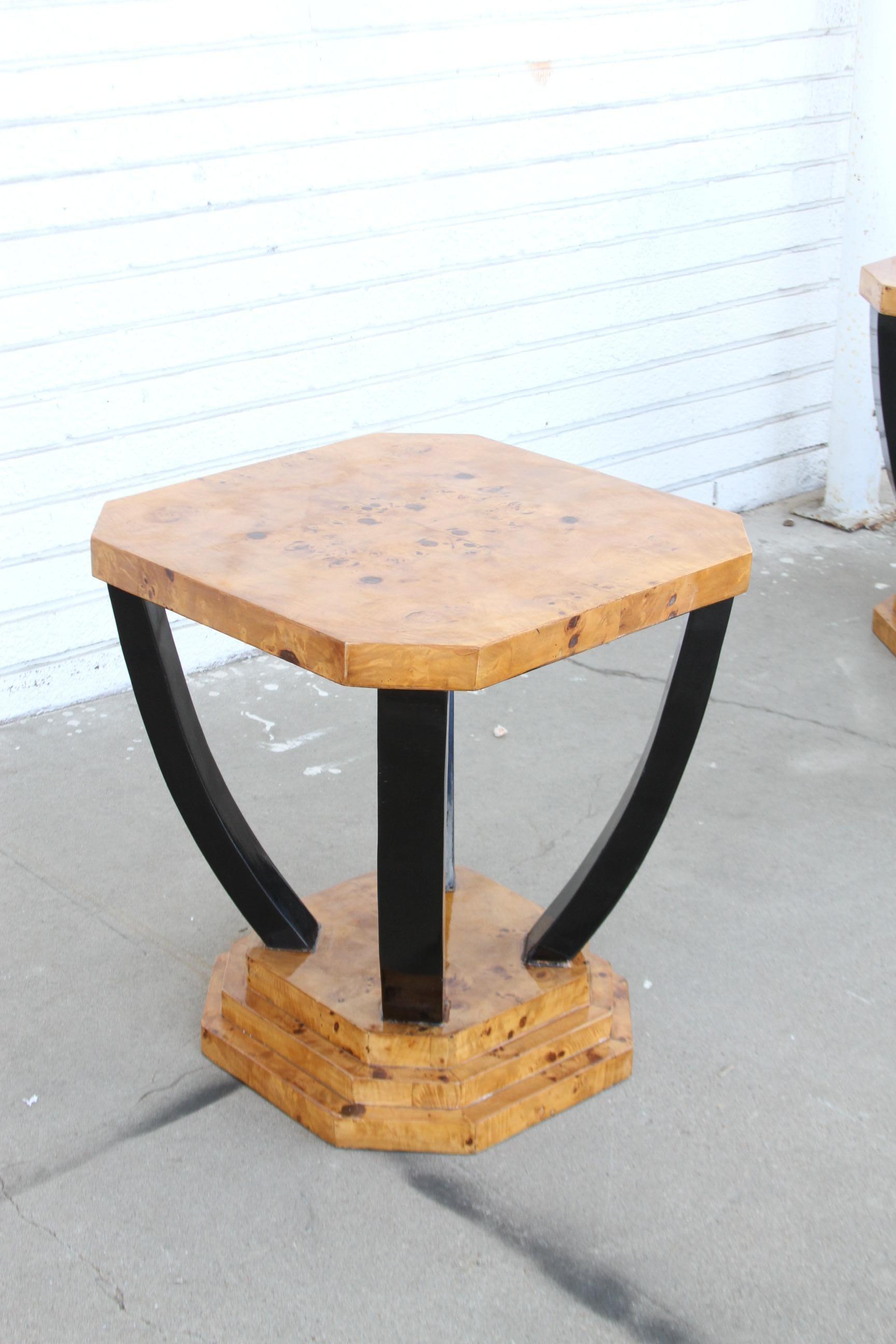 This is a wonderfully made pair of Art Deco Style tables. They have a sculptural look that's totally Art Deco. They're constructed of a burl wood and have ebony lacquer accents. They have a 3 step base that's also made of burl wood.

A beautiful
