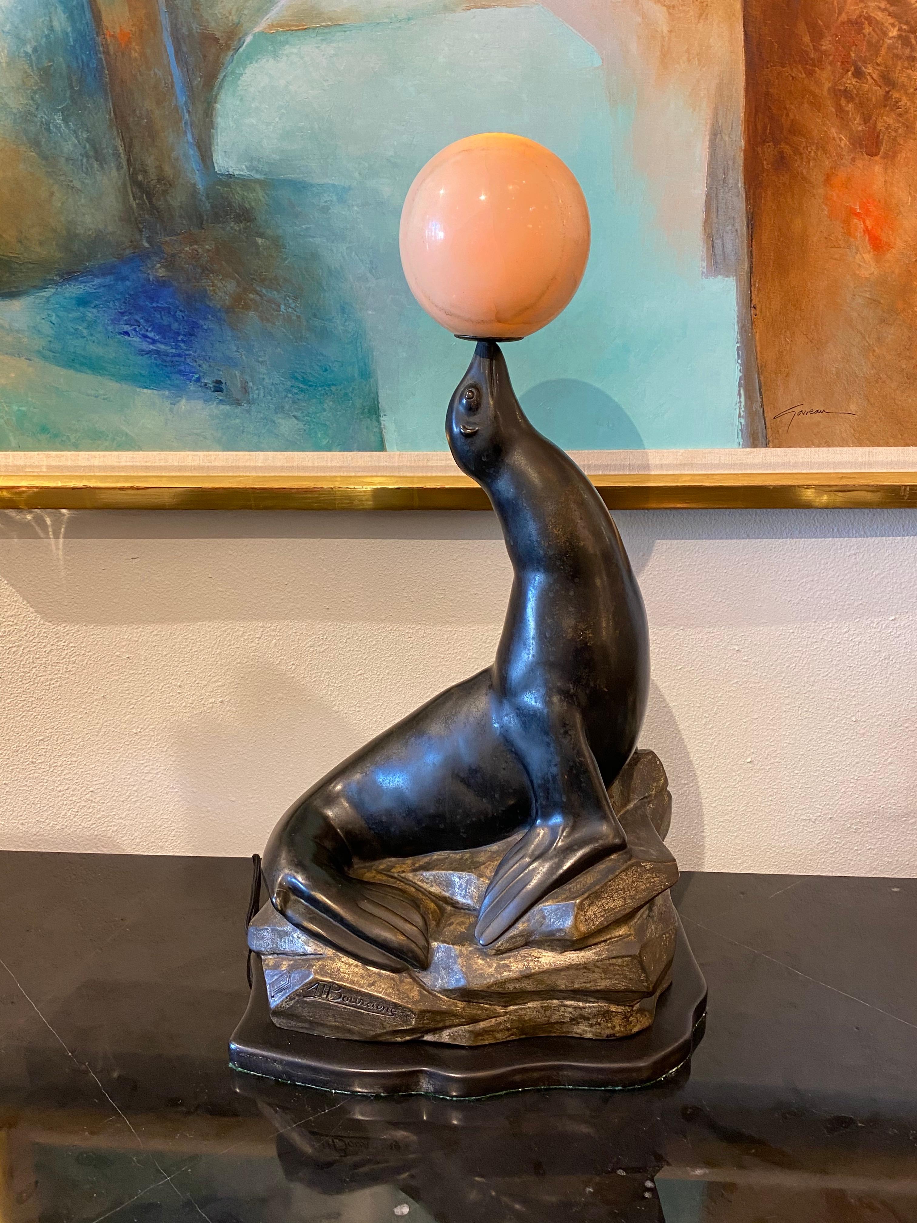 Art Deco sculpture of a seal figure with illuminated onyx ball by Marcel A. Bouraine.
Made in France 
Dated 1931
Signature: Inscribed 