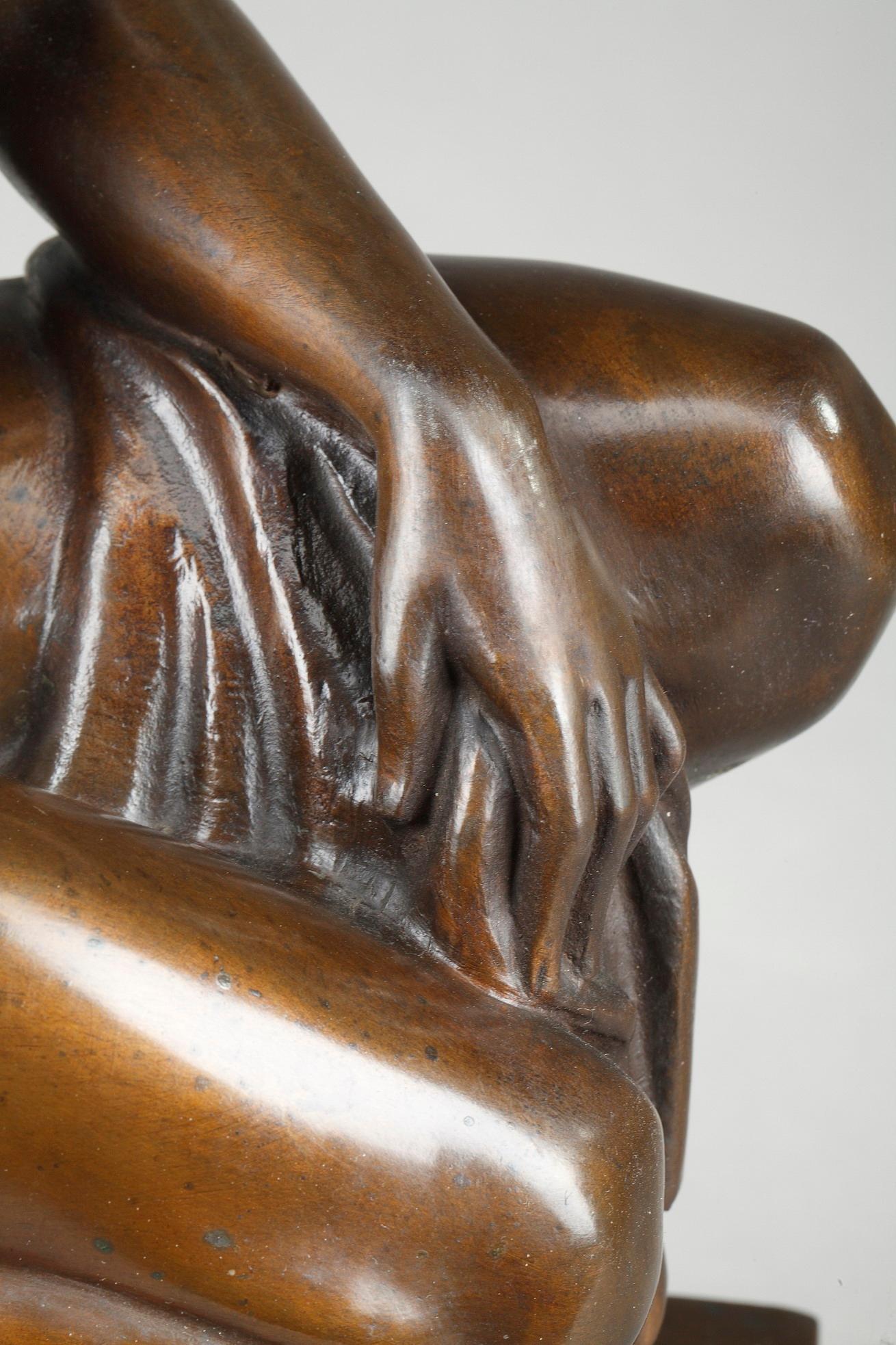 Art Deco sculpture crafted of bronze with brown patina, depicting a nude crouched woman holding a drapery. The figure is resting on a red and beige marble plinth. The bronze is marked FZP and dated 1921. Rectangular stamp, marked: Kunstanstalt WMF