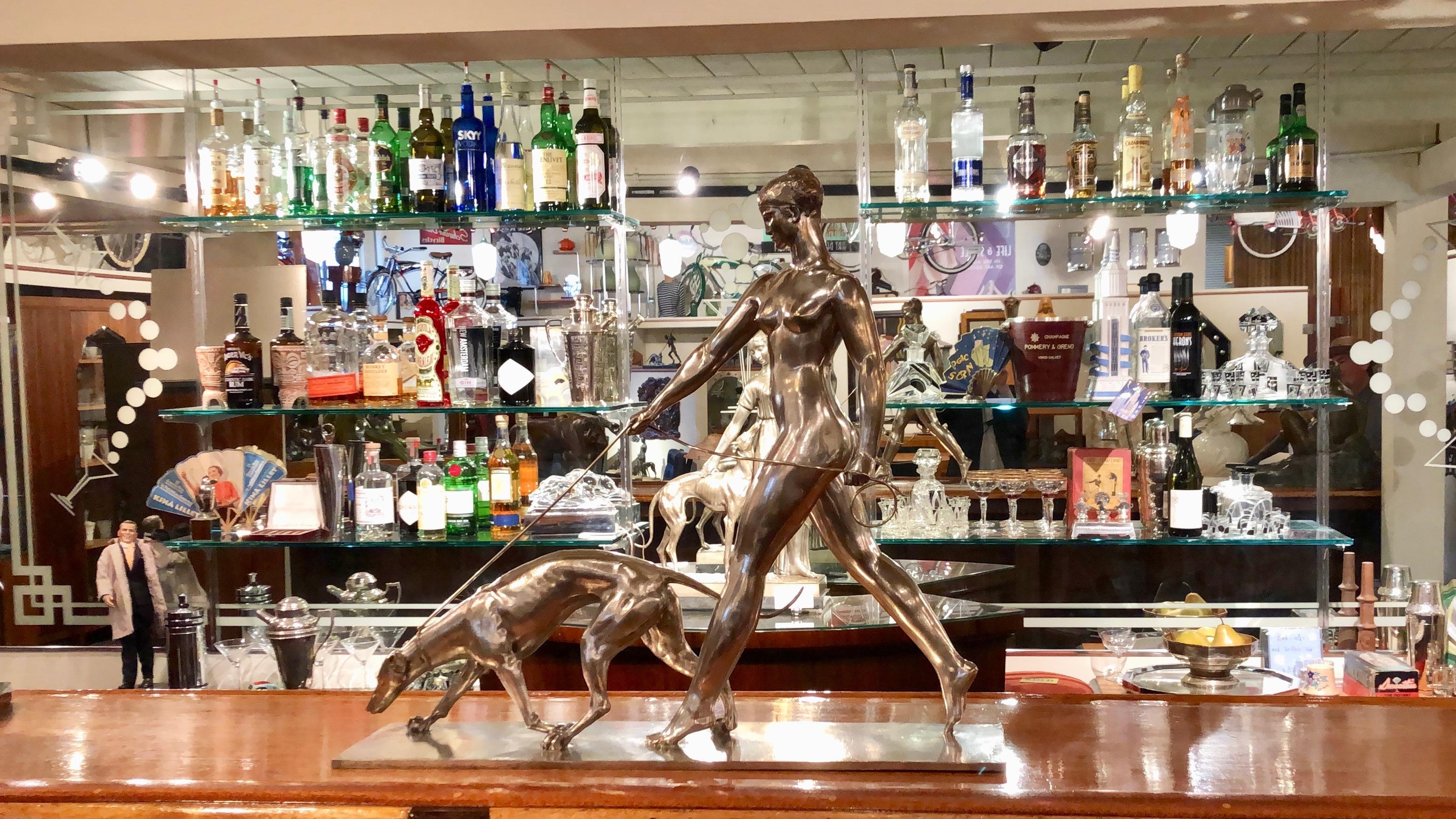 Femme au Levrier art deco statue by Raymond Leon Rivoire, circa 1925. A most important iconic image depicting the goddess of hunting Artemis (or Diana in the Roman Mythology) and her greyhound dog. Beautifully sculpted bronze statue in the most rare