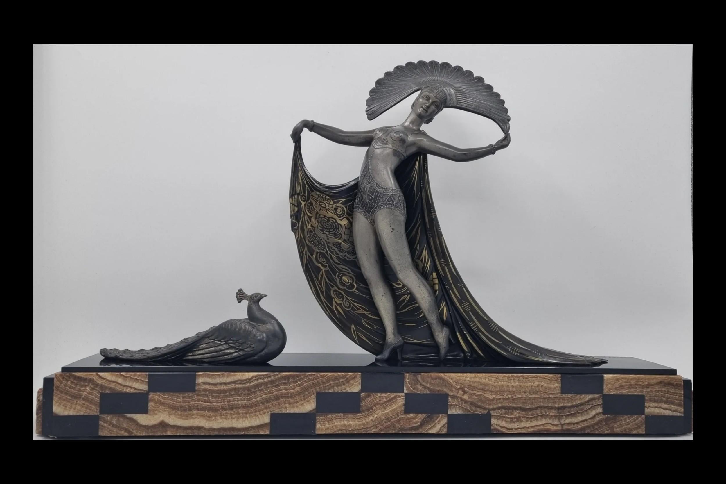 An impressive and rare Art Deco sculpture modelled as a cabaret dancer with a peacock. Crafted from cold-painted spelter, mounted on a stepped marble and onyx base. Created and signed by the esteemed Artist of Art Deco era, Lucien Gibert