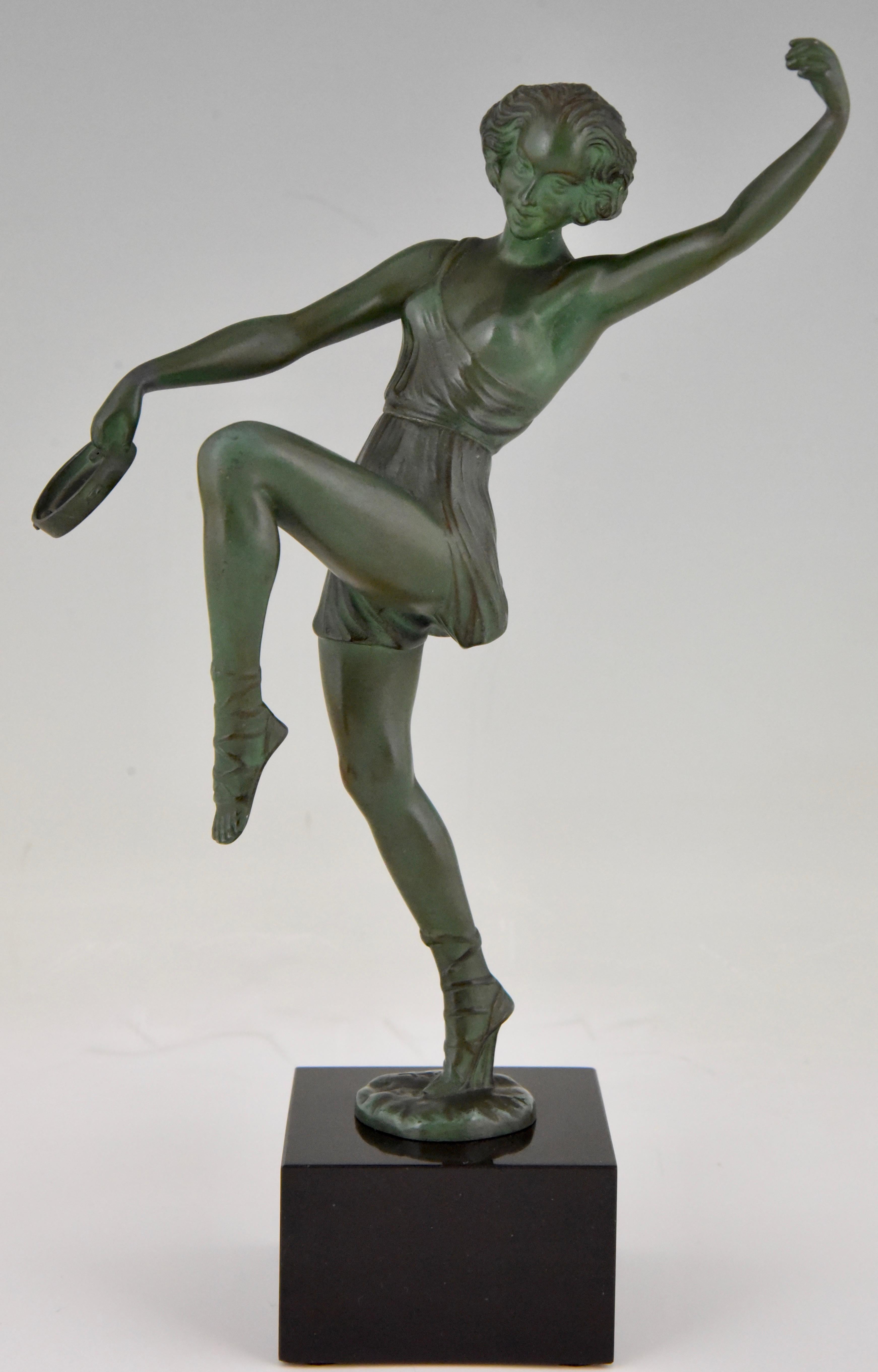 Art Deco sculpture of dancer with tambourine by Fayral, pseudonym of Pierre Le Faguays, France 1930. Patinated Art metal on a Belgian Black marble base.
 