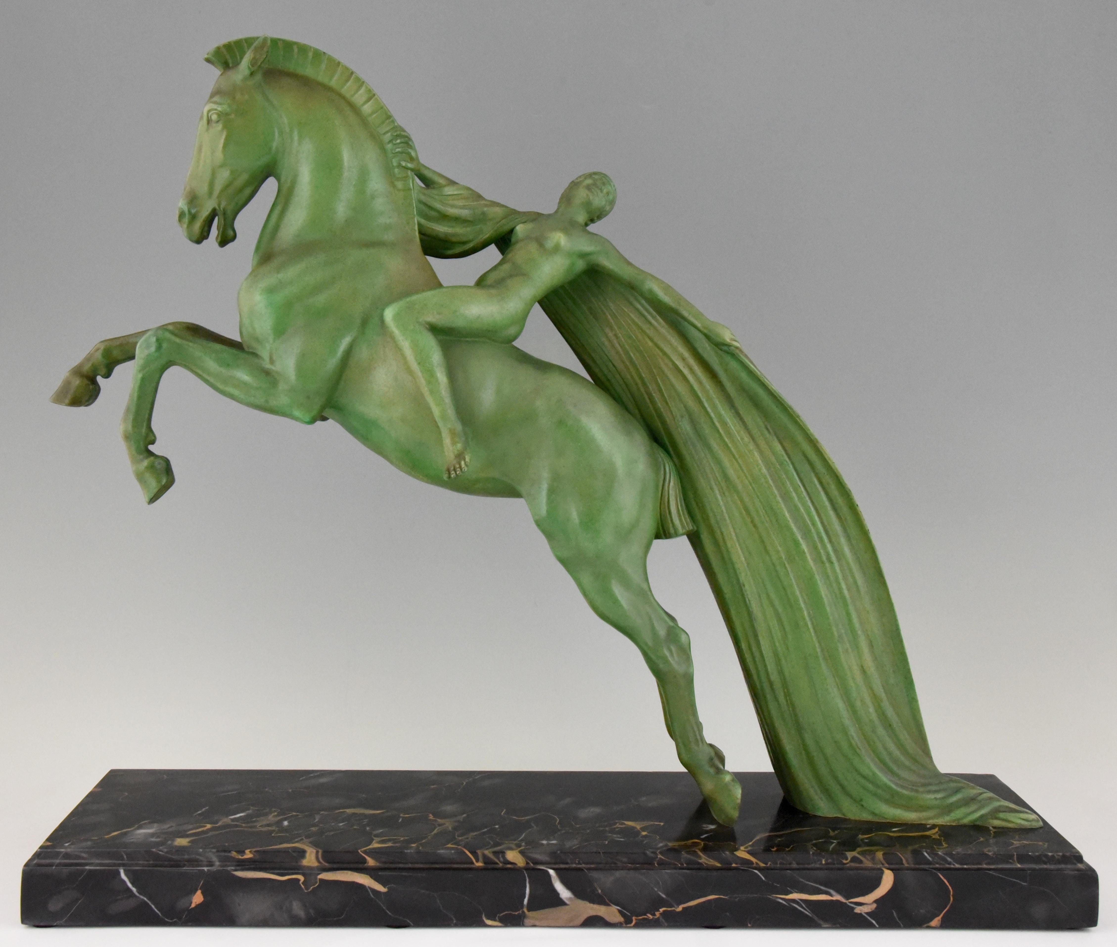 Spectacular large Art Deco sculpture of a nude on a rearing horse by the French artist Charles Charles, circa 1930. Lovely green patina, Portor marble base.