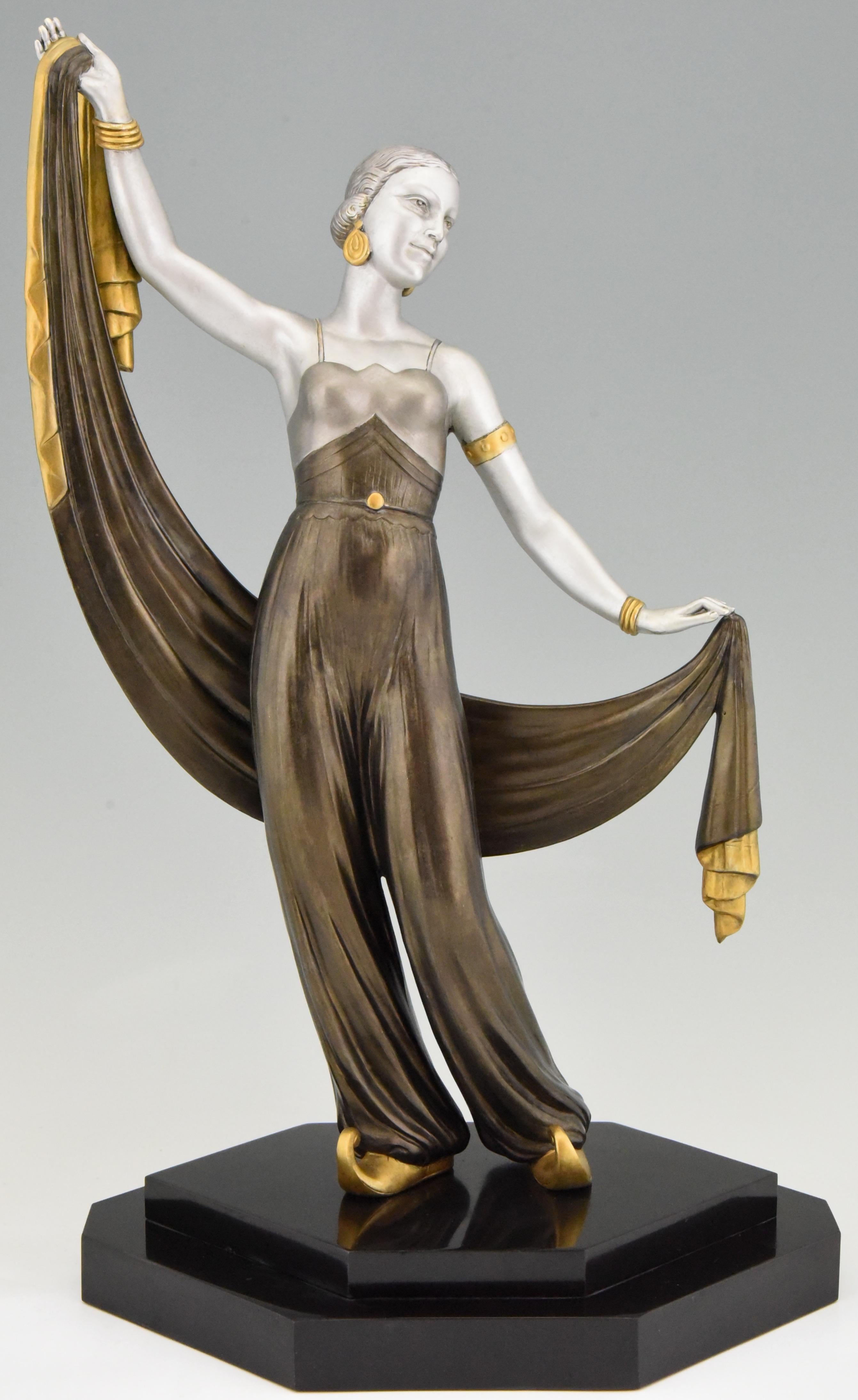 Tall Art Deco sculpture of an orientalist harem dancer with scarf mounted on a Belgian black marble plinth. The sculpture has a lovely multi-color patina and is signed Salvador, France, 1930.