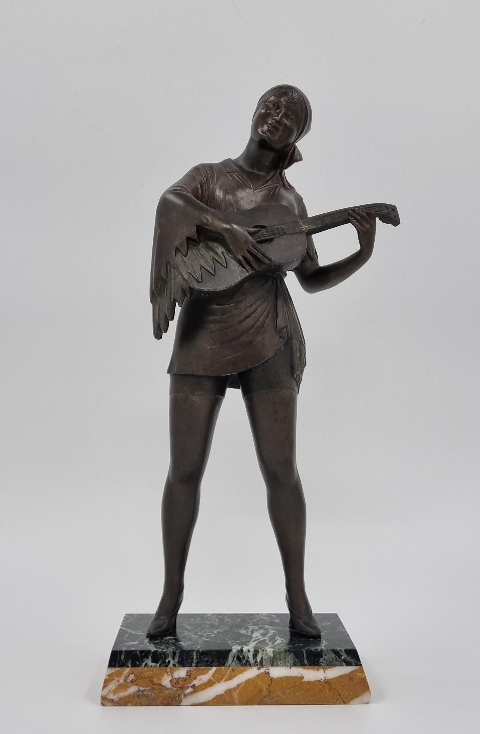 Tall Art Deco sculpture of a lady playing the guitar, cast in cold painted spelter, depicted wearing a flowing gypsy-style intricately detailed costume , with every fold and movement captured perfectly. All crafted to give an impression of the style